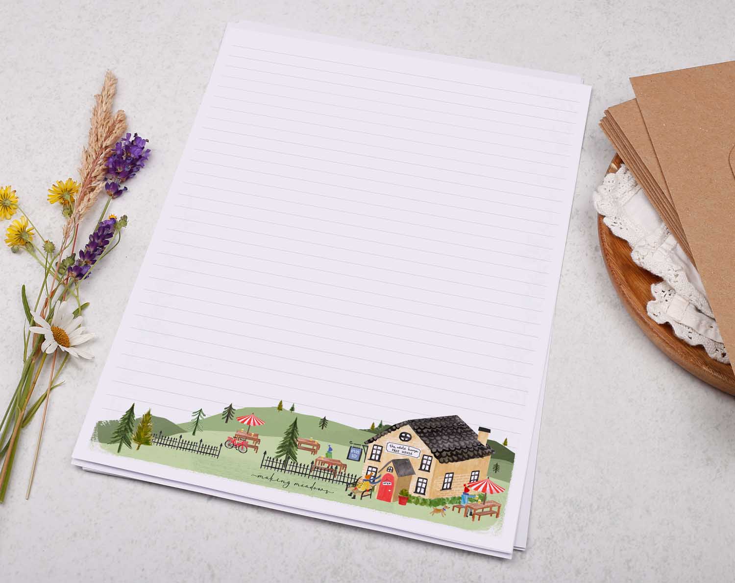 A4 letter writing paper sheets with a cute illustration of a countryside pub surrounded by rolling hills.