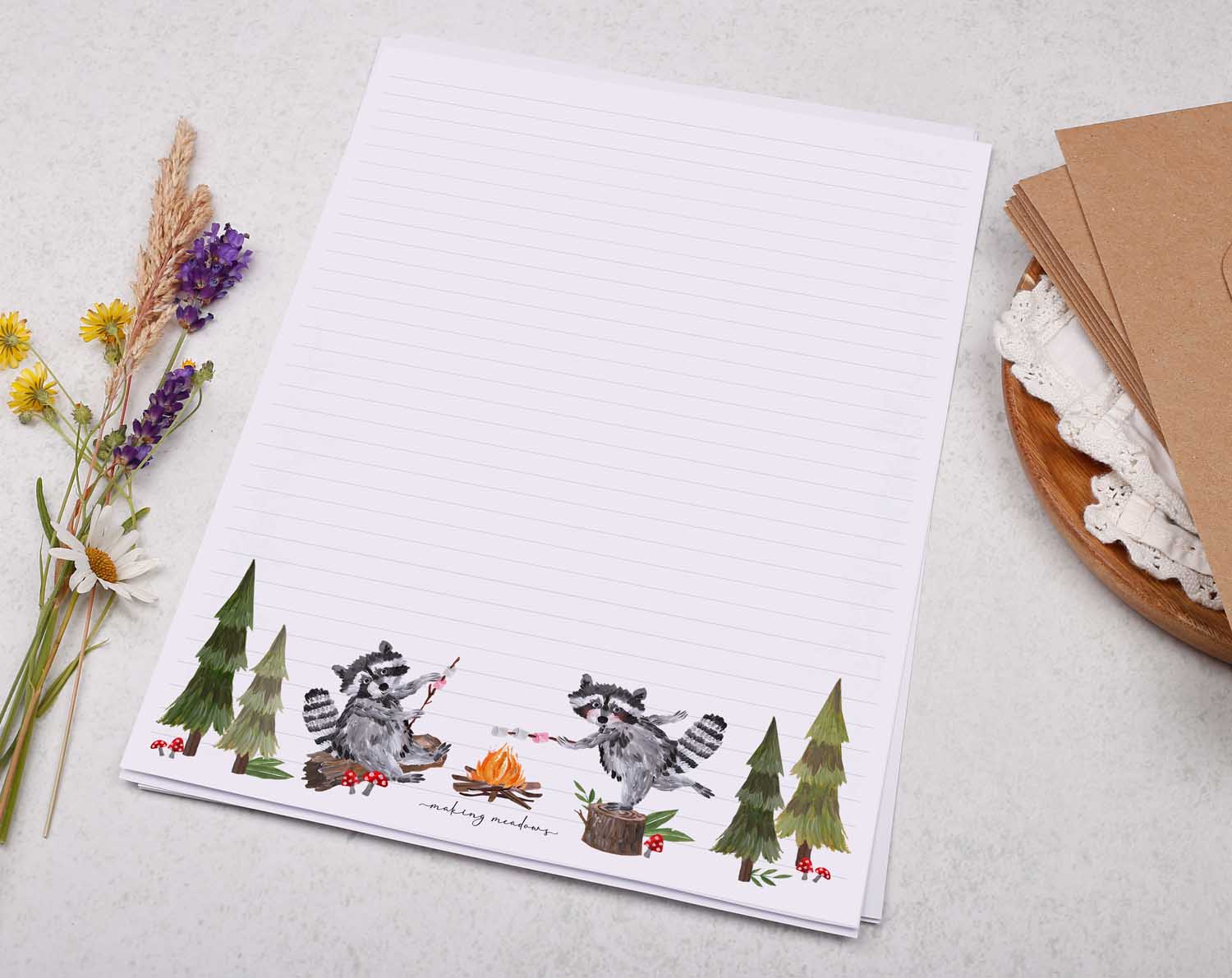 A4 letter writing paper sheets with a cute illustration of some raccoons camping in the forest.