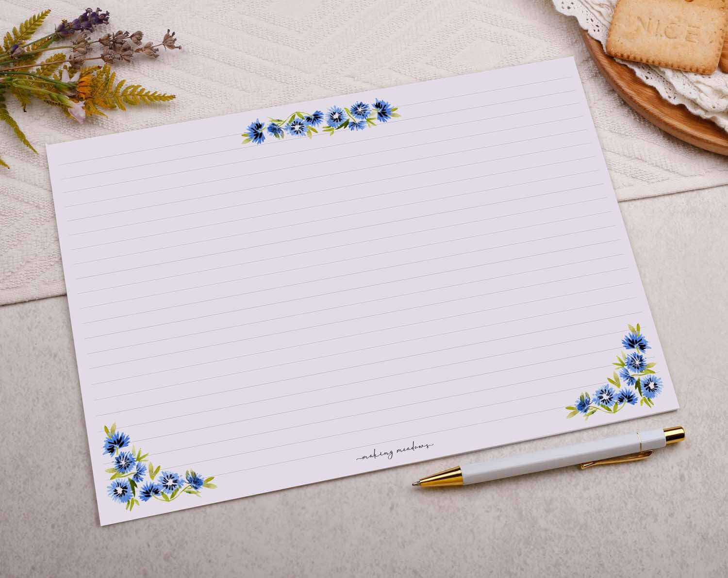A4 writing paper featuring watercolor blue flowers at the corners, designed for origami envelopes and letter writing.