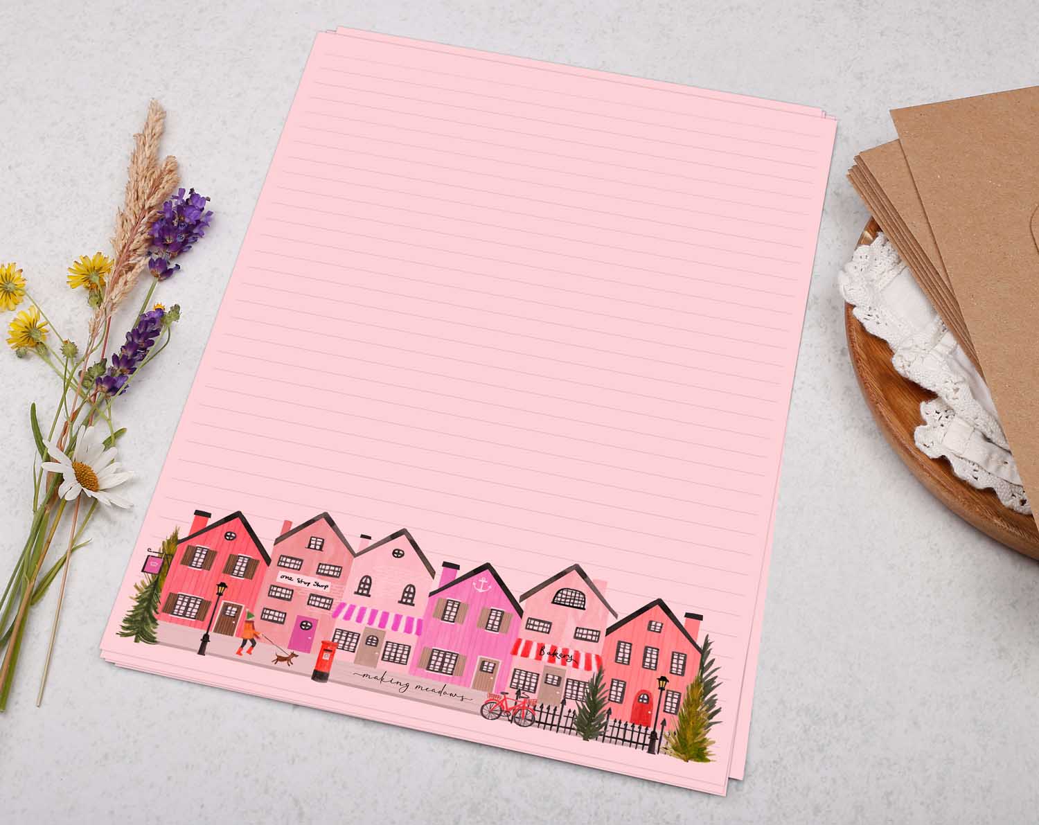 A4 pink writing paper with village shops. Stationery designed by Making Meadows