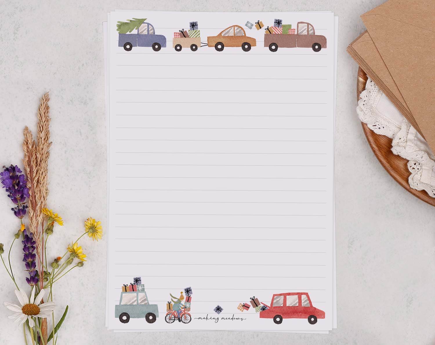 A5 writing paper with Driving Home For Christmas featuring decorative cars and gifts.