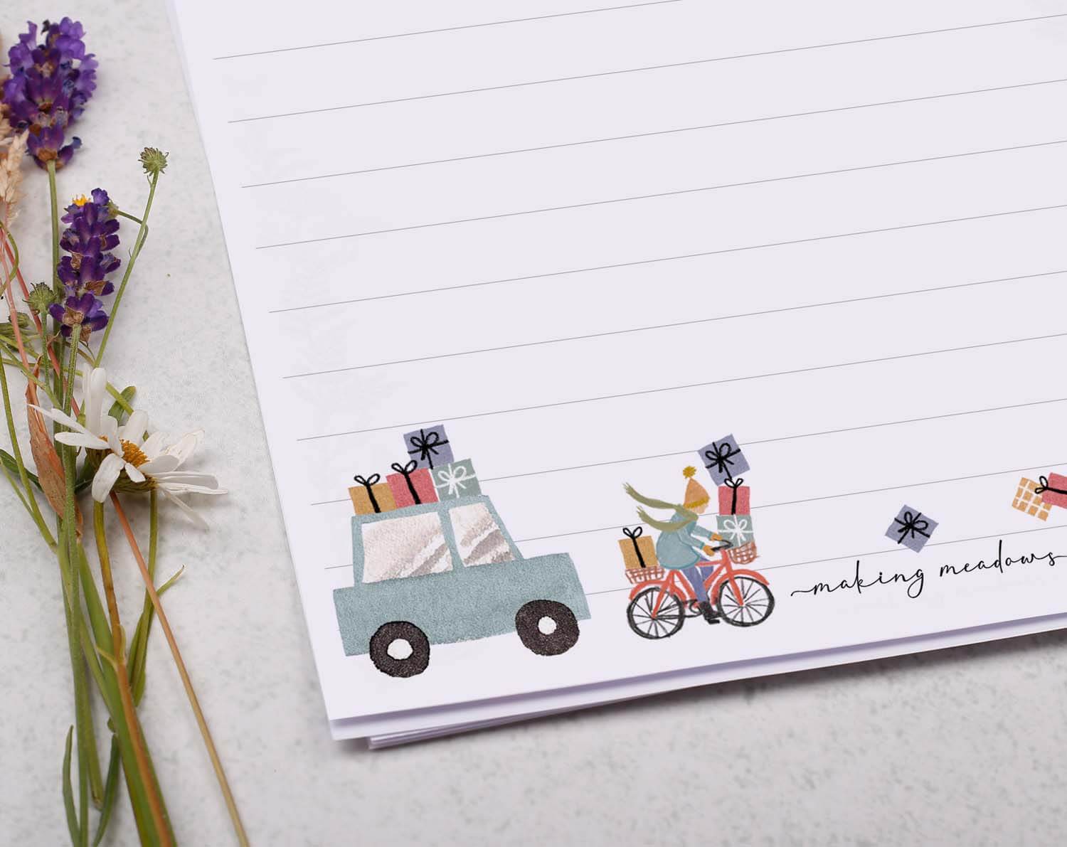 A5 writing paper with Driving Home For Christmas featuring a decorated truck and bicycle delivering gifts.