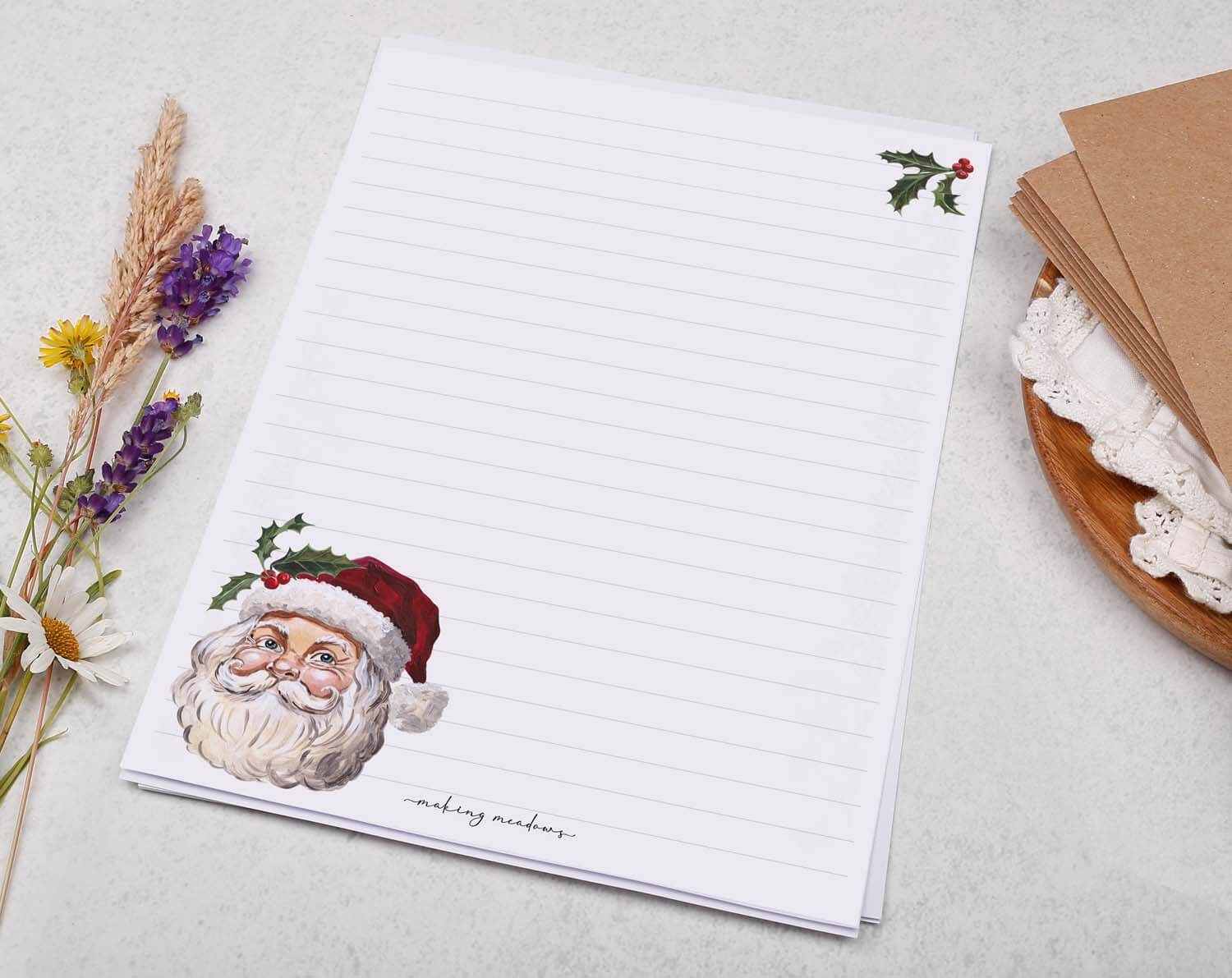 A5 writing paper with Father Christmas featuring a festive Santa illustration and decorative holly leaves.