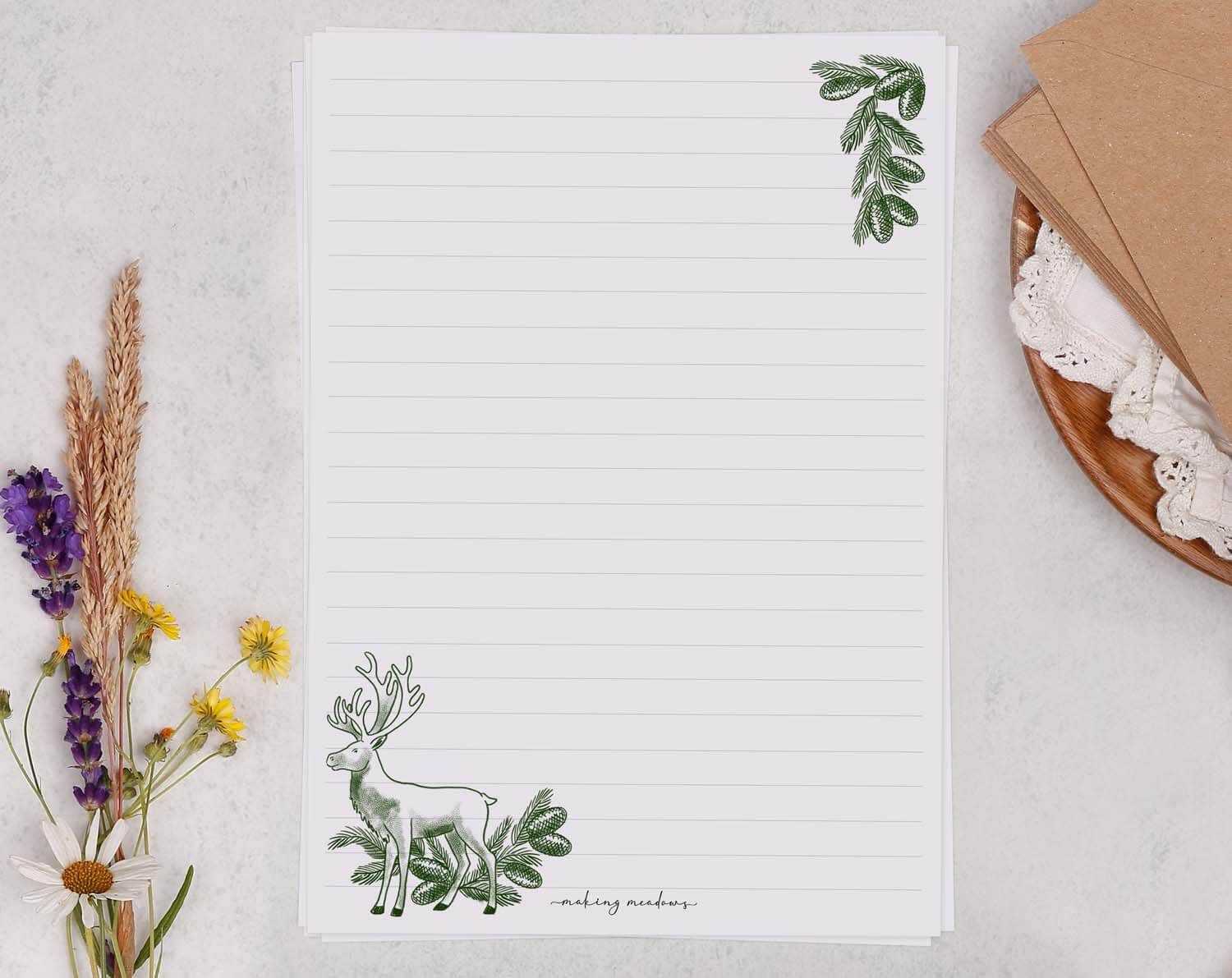 A5 writing paper with Traditional Reindeer featuring floral accents and lined layout for notes or letters.