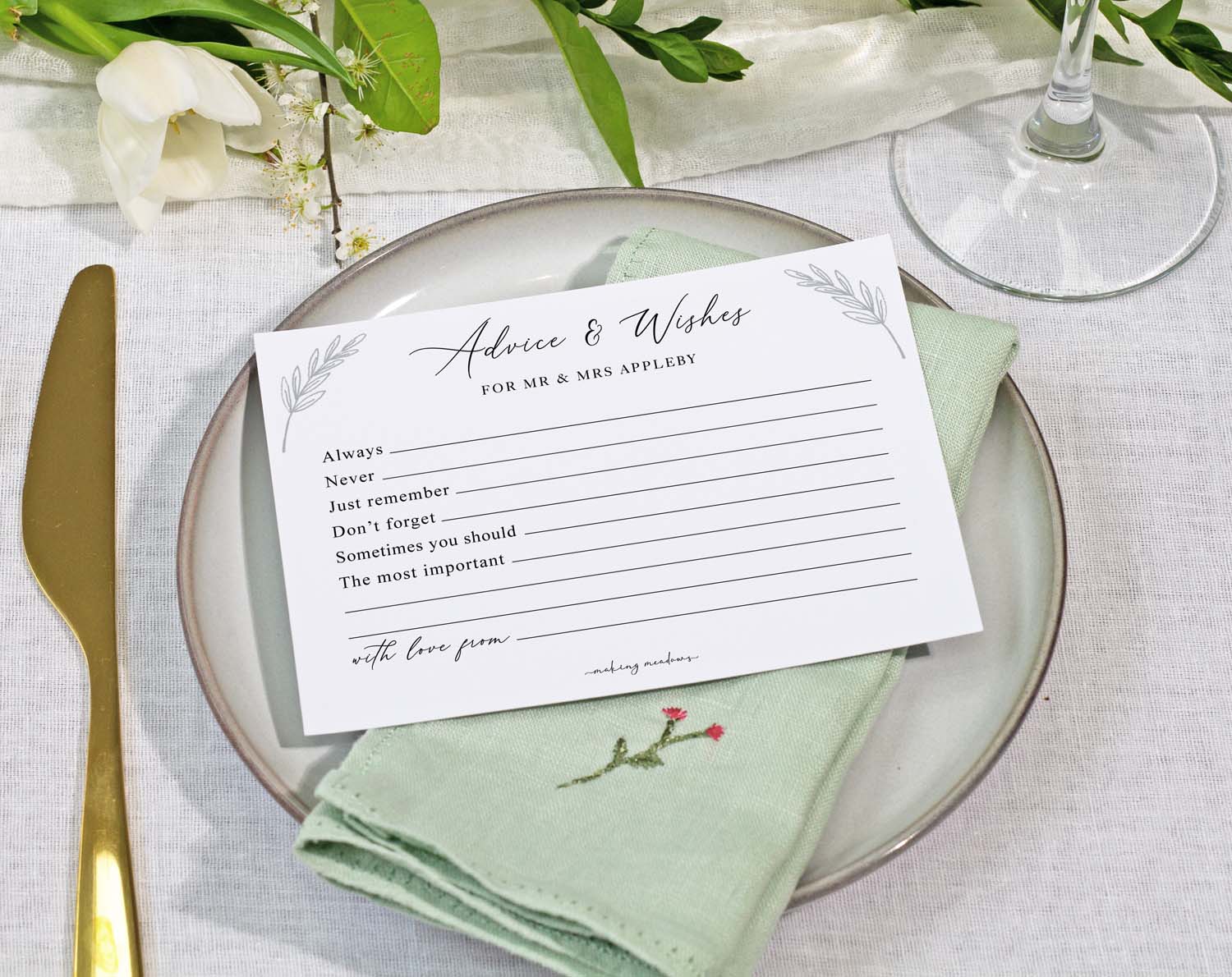 Minimalist Wedding Advice Cards displayed on a plate with a green napkin, encouraging guest messages for the couple.