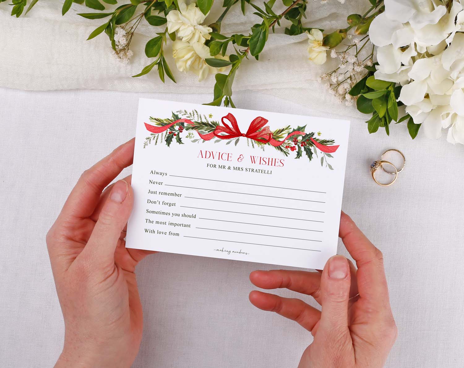 Person holding Winter Wedding Advice Cards with floral design and heartfelt messages.