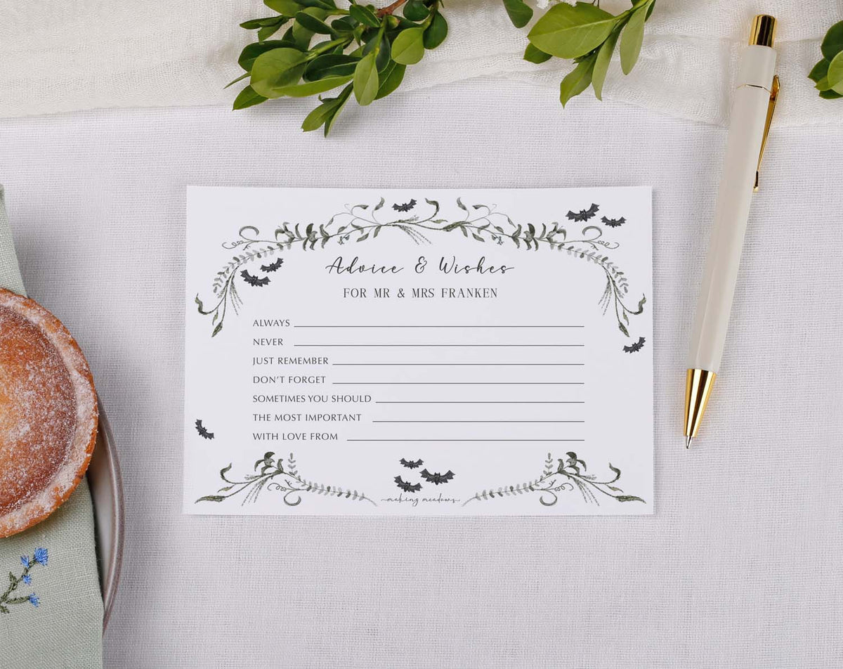 Gothic Wedding Advice Cards displayed on a table with a pen and a dessert, perfect for capturing guest messages.