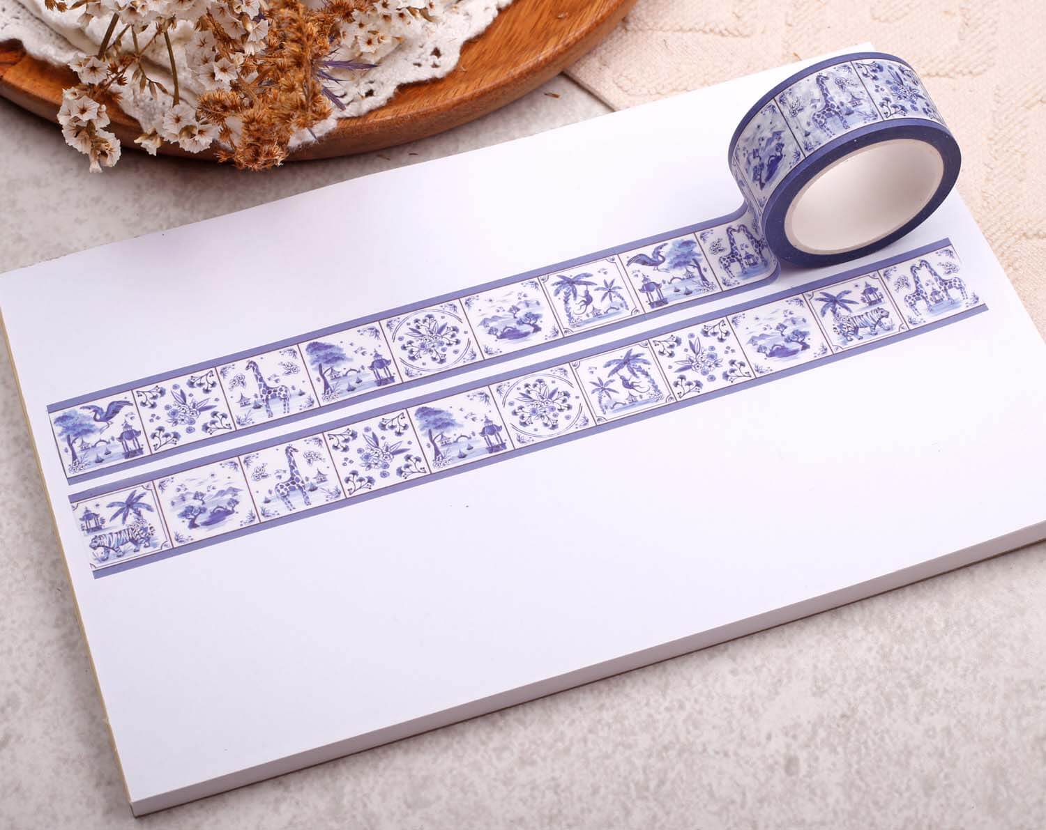 Animal Washi Tape on a notepad, showcasing a blue floral design, perfect for crafts and journaling.