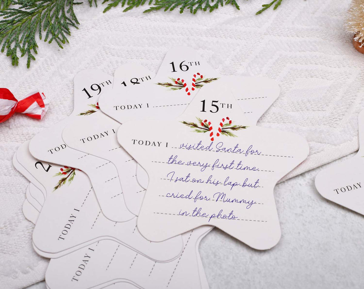 Close-up of Baby's First Christmas Advent keepsake cards featuring handwritten memories for each day of December.