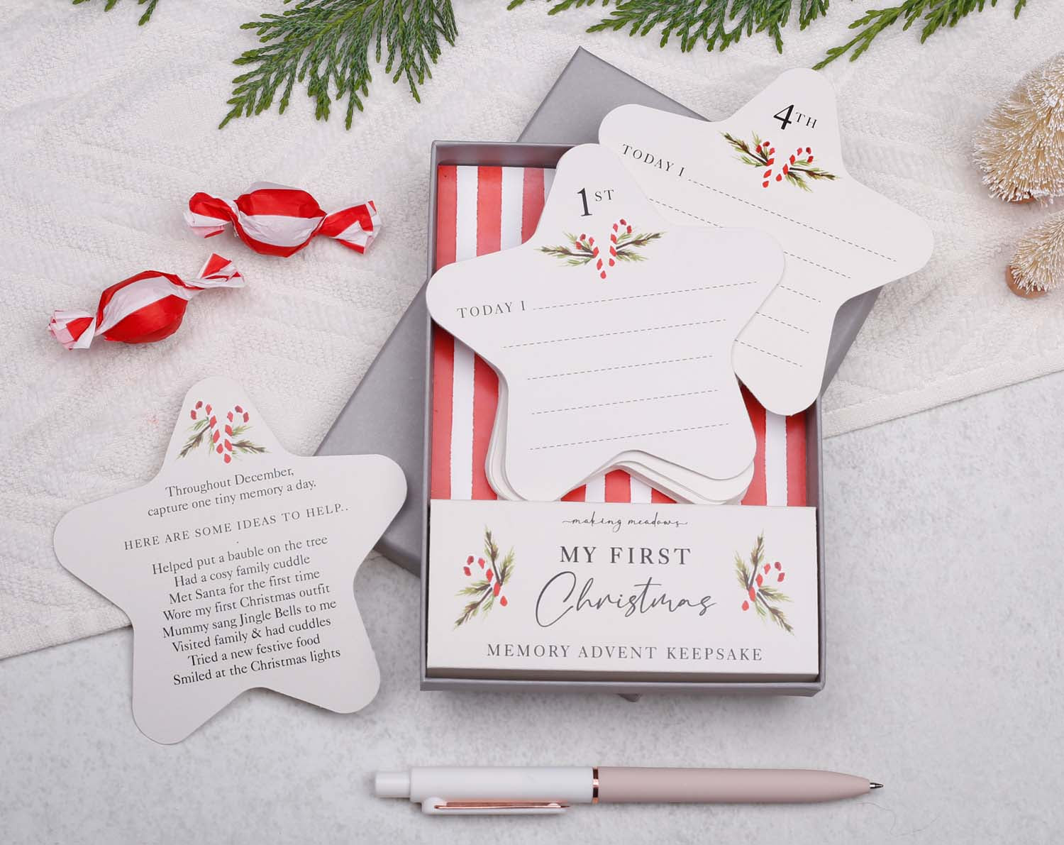 Baby's First Christmas Advent Keepsake featuring star-shaped memory cards and a decorative box.