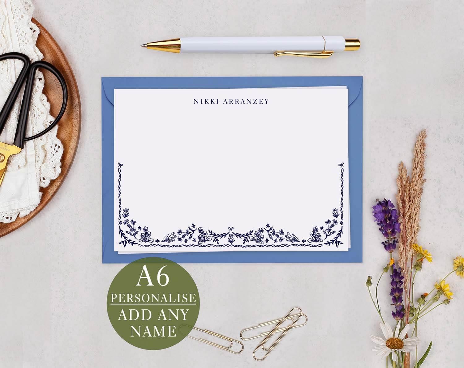 Blue Floral Personalised Note cards displayed on a table with a pen and clips, featuring elegant floral design.