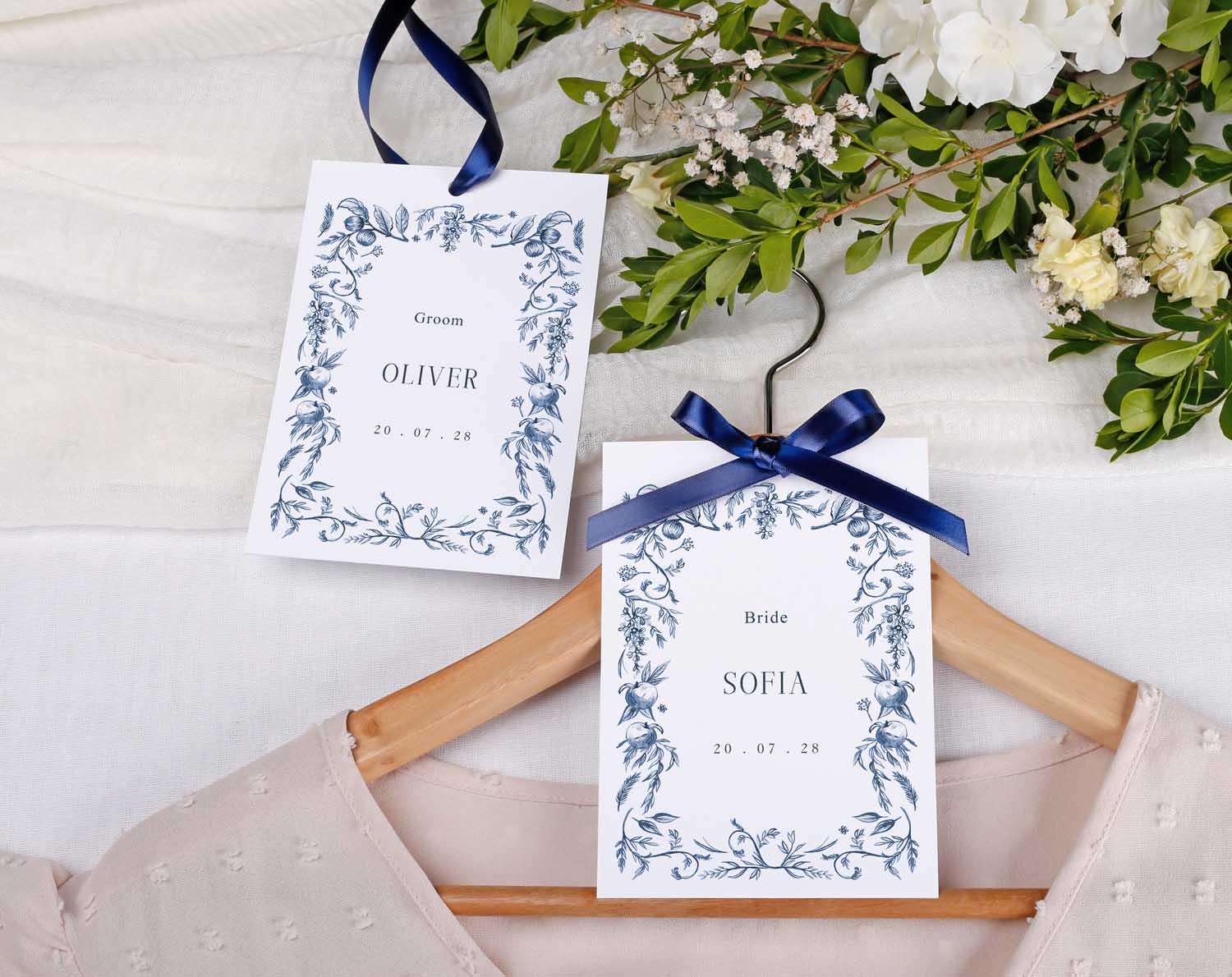 Blue Garden Wedding Hanger Tags for bridal party with groom and bride names on elegant floral design.