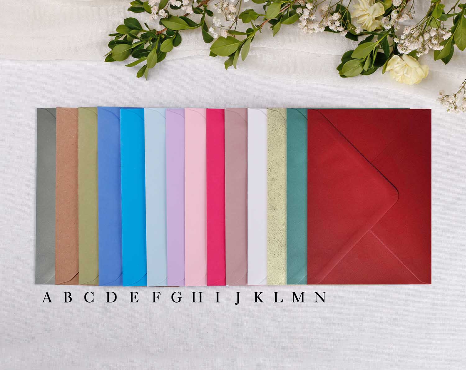 Colourful selection of envelopes for Wedding Invitations showcasing various shades and styles.