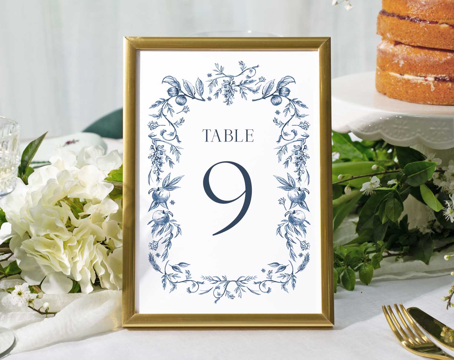 Blue Garden Wedding Table Numbers featuring Table 9 in a floral frame on a reception table.