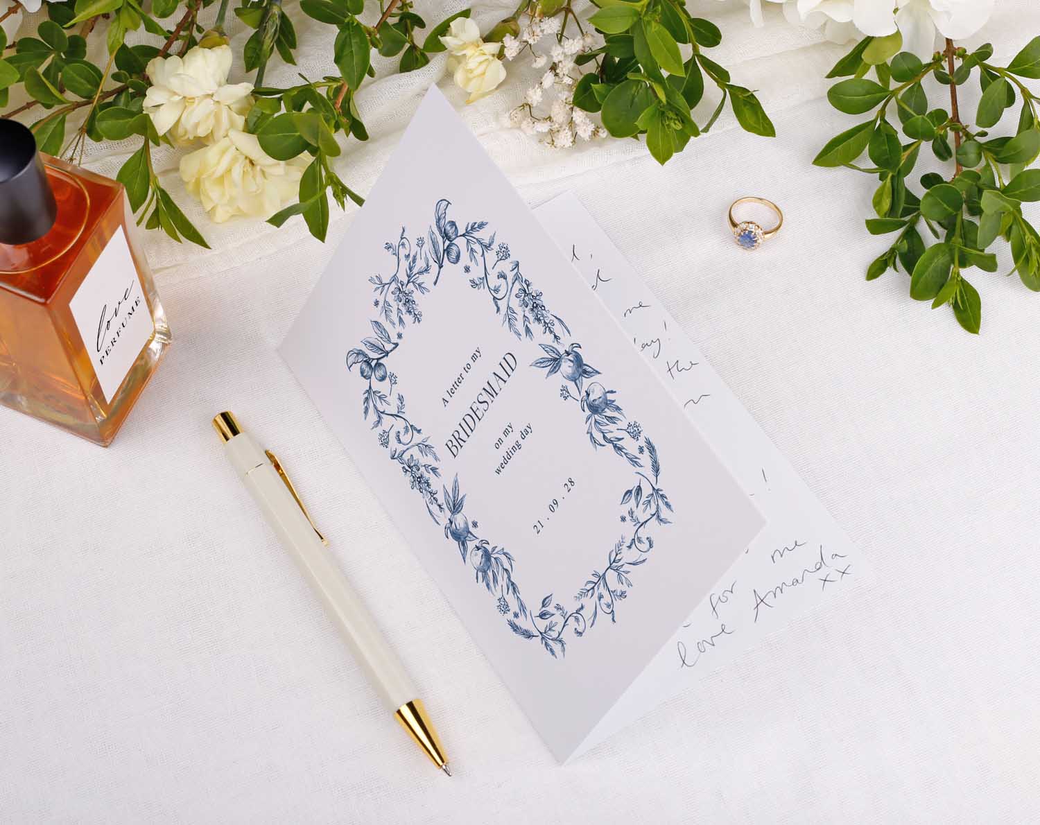 Blue Garden Wedding Thank You Card for Bridal Party displayed with a pen, perfume, and ring on a table.