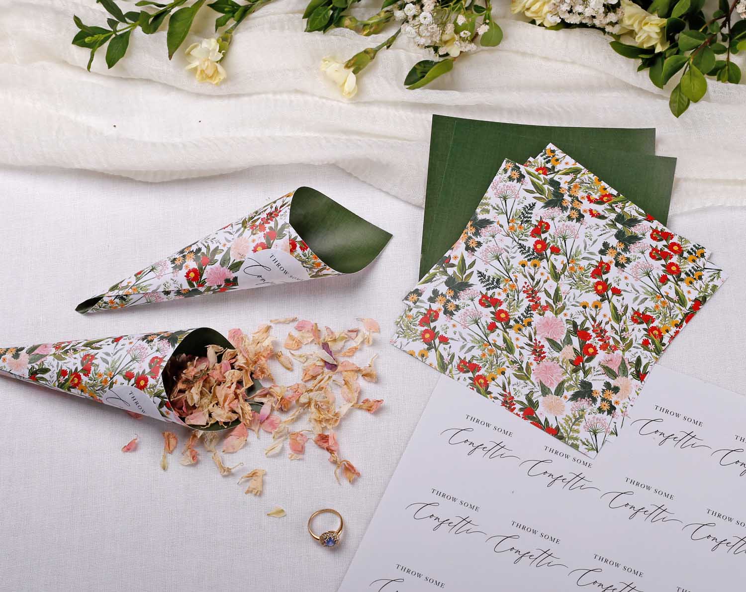 Boho Wedding Confetti Cones filled with floral confetti, surrounded by decorative paper and wedding ring.