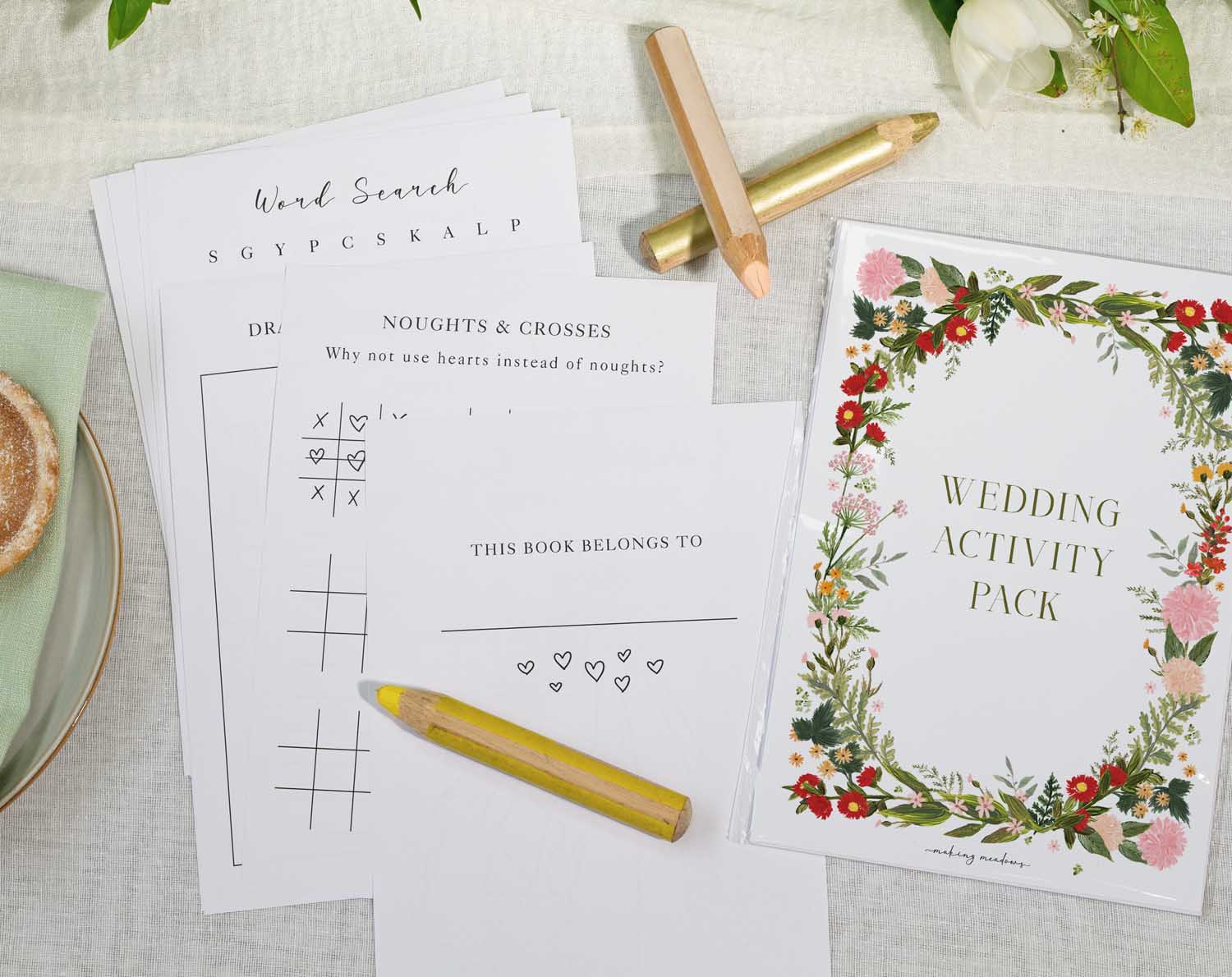 Boho Wedding Kids Activity Pack showcasing activity sheets and colorful pencils on a wedding table.