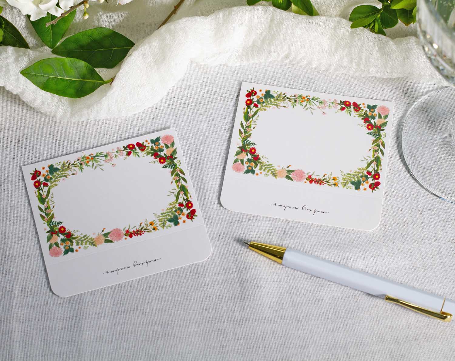 Boho Wedding Place Cards with vibrant floral design on a table setting for a wedding.