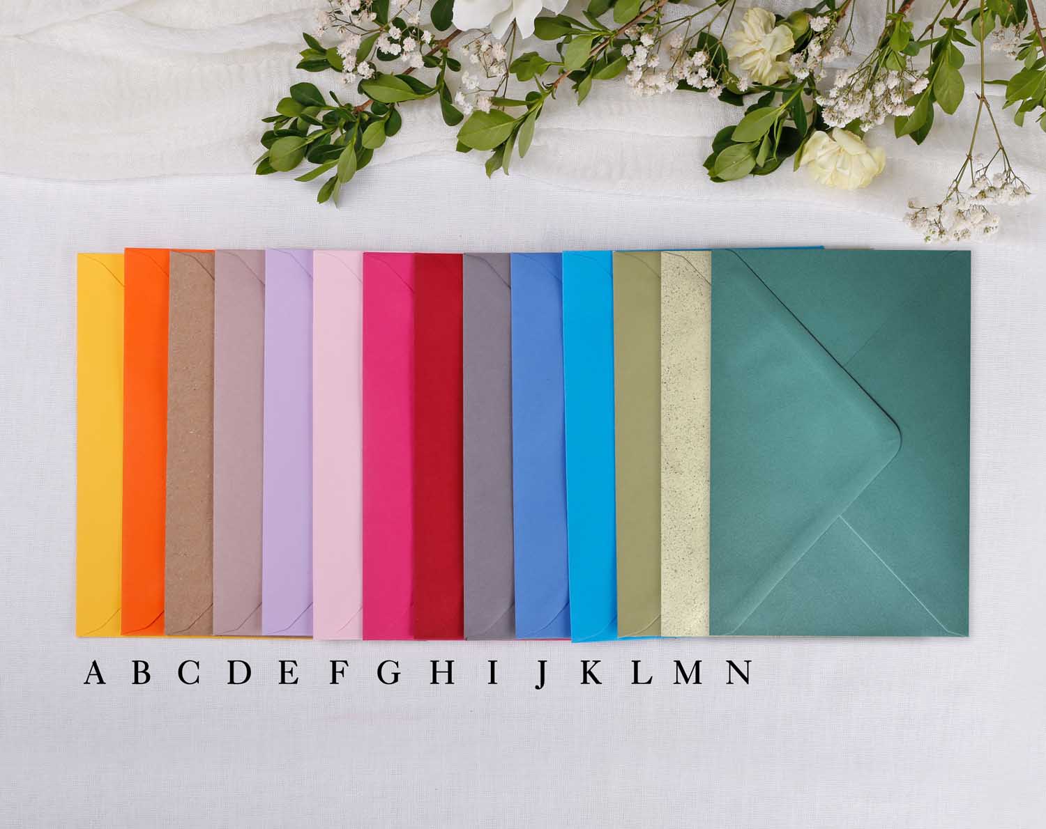 Various colourful envelopes for wedding thank you cards, showcasing vibrant hues and elegant designs.