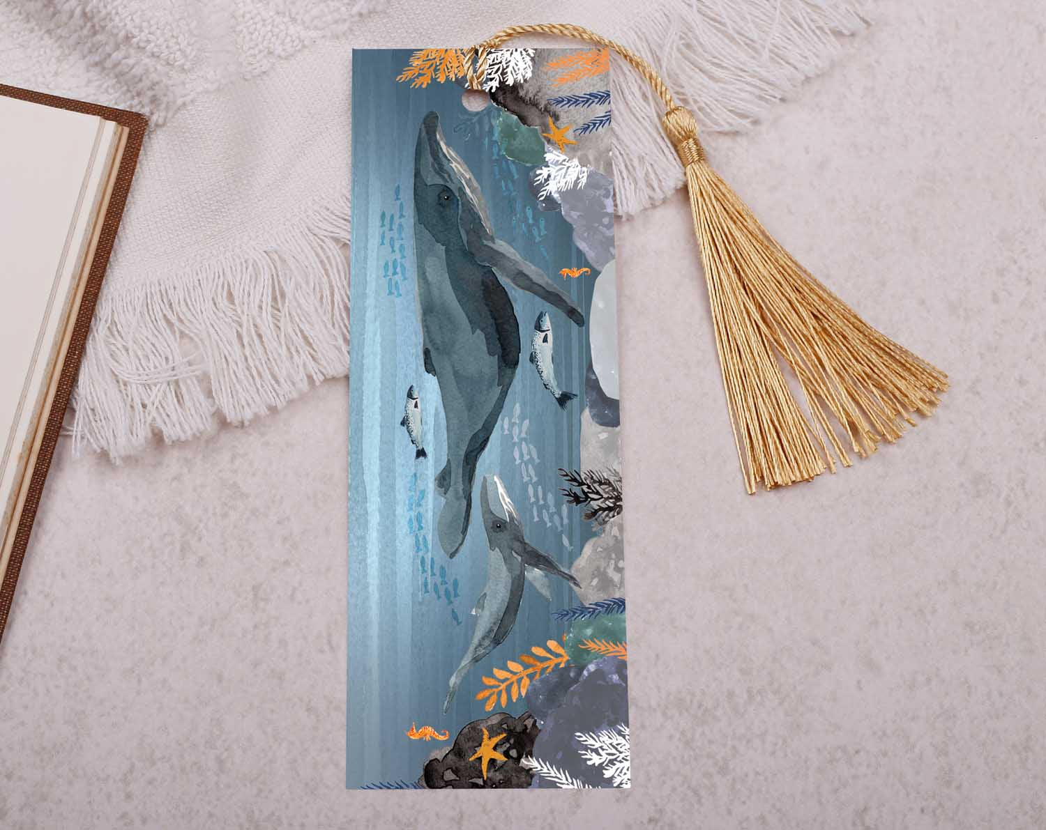 This beautiful paper bookmark is double sided. The main side features two whales swimming in the deep sea whilst the flip side shows a complimentary pattern & an illustrated icon.