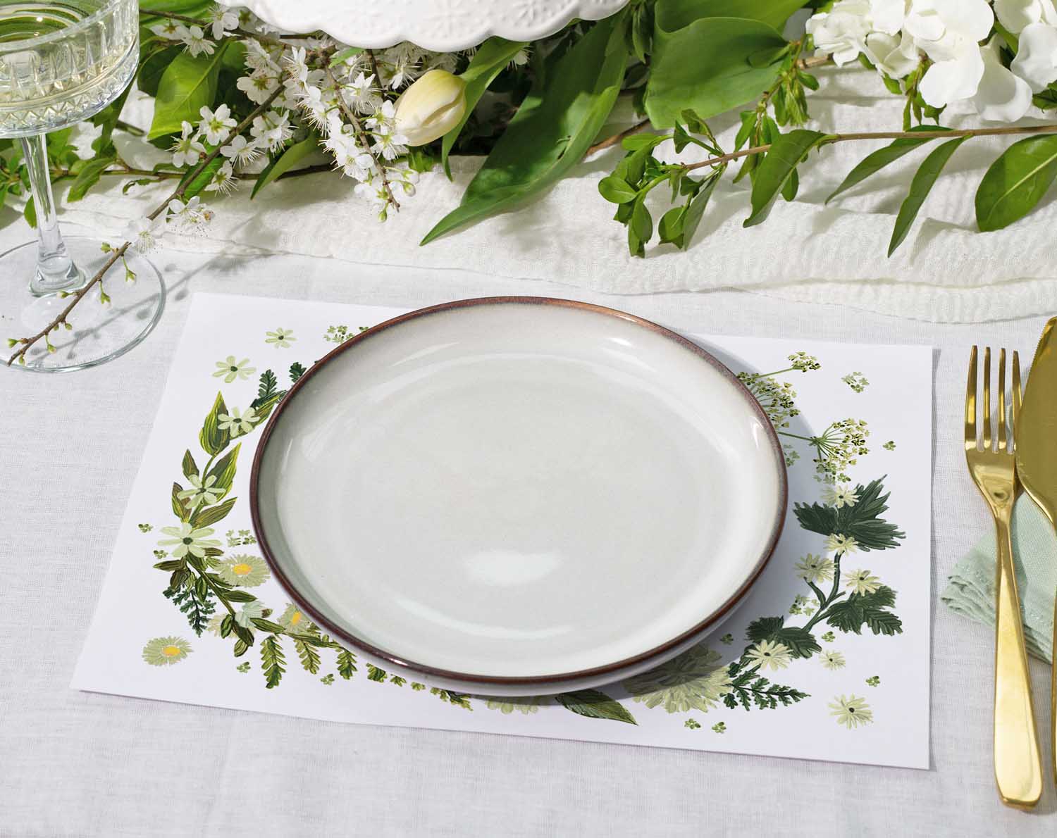 Botanical Wedding Placemats featuring a decorative floral design with a white plate and gold cutlery on a table setting.