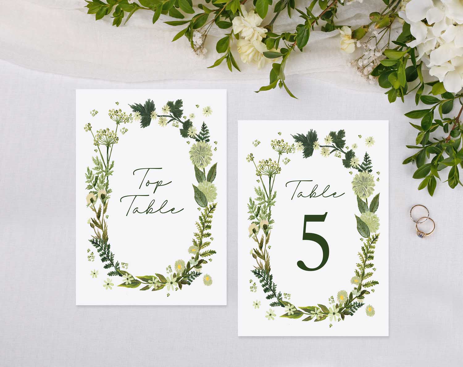 Botanical Wedding Table Numbers featuring greenery and floral designs for wedding receptions.