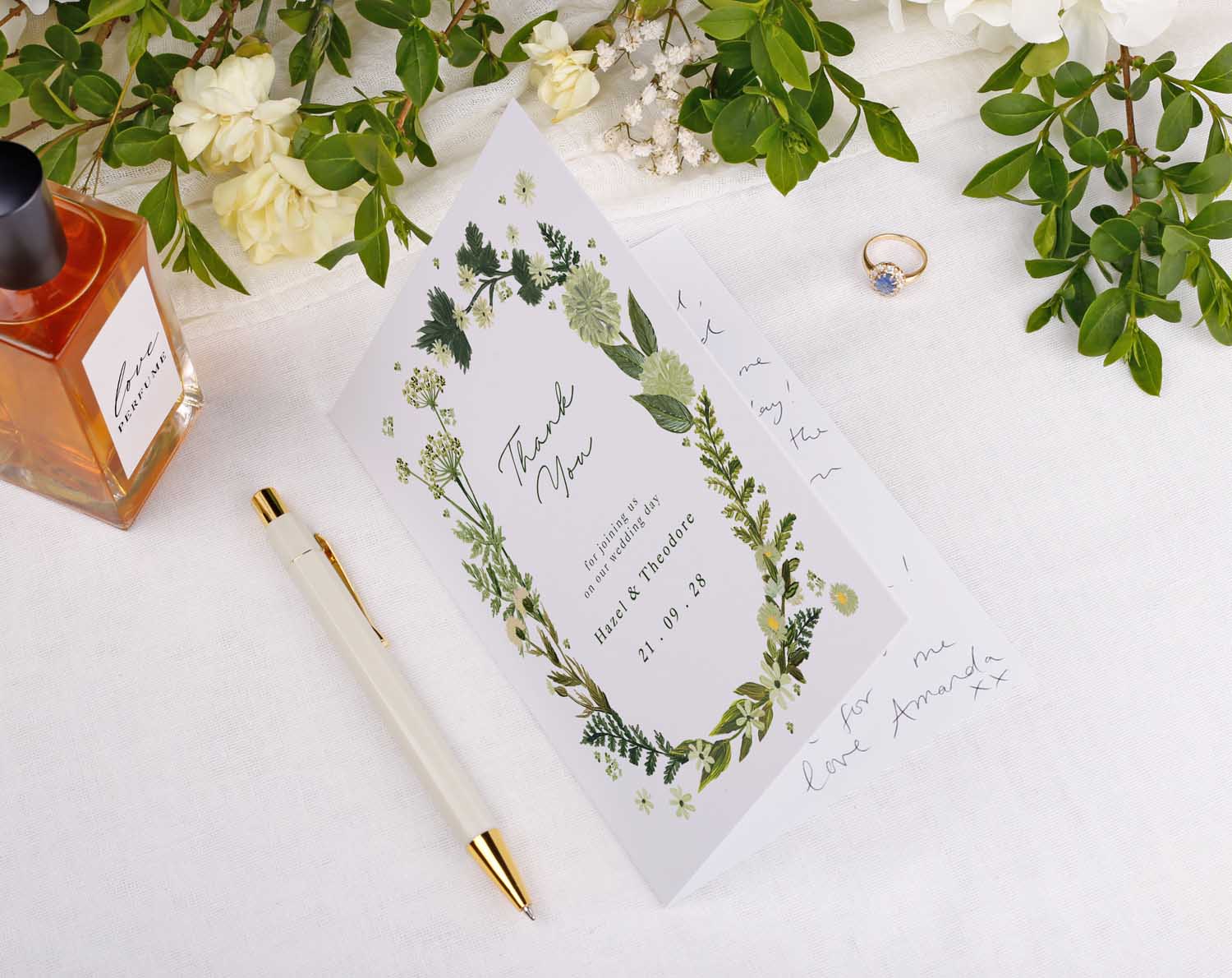 Botanical Wedding Thank You Cards displayed with a pen, perfume, and ring on a white background.