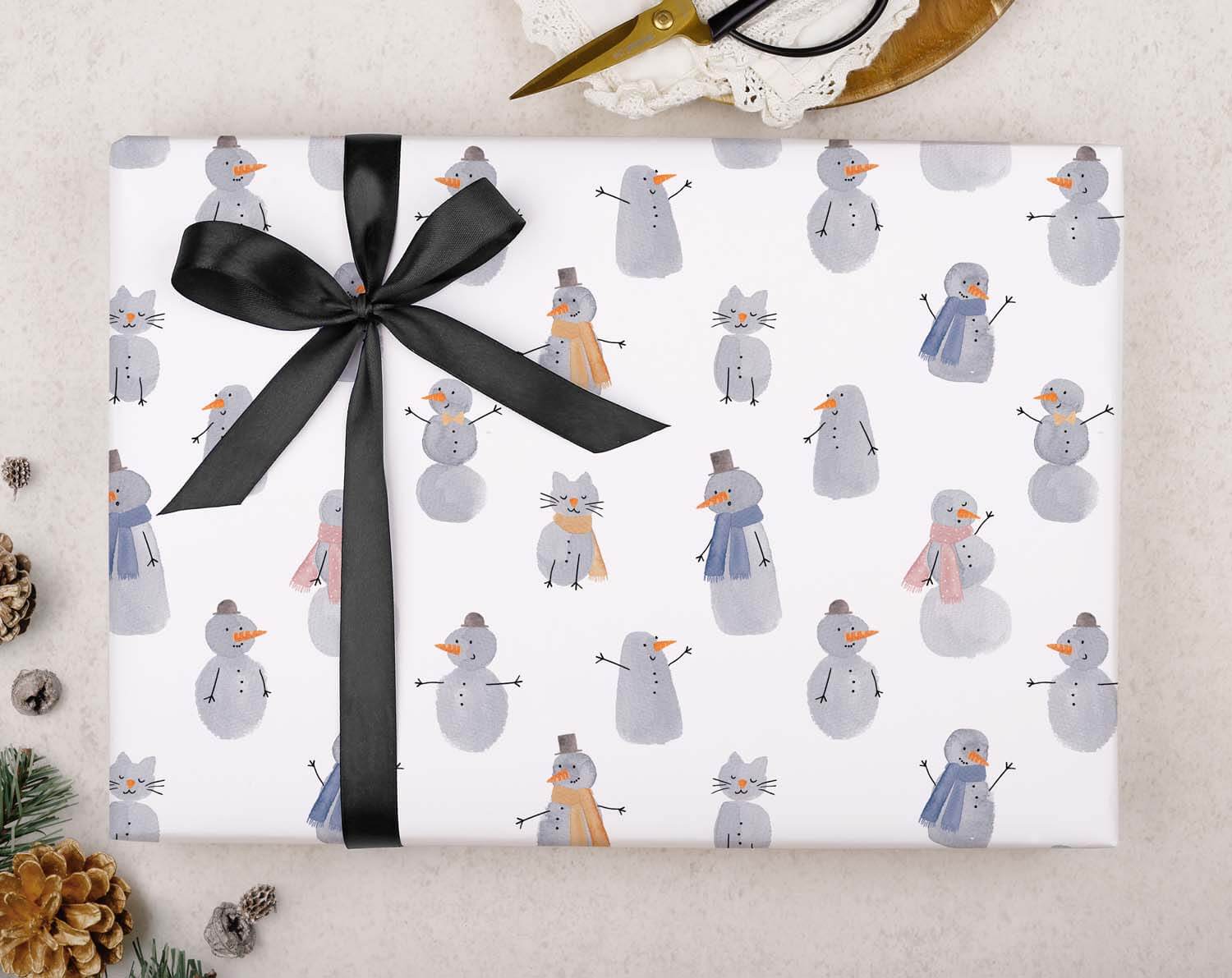 Children's Snowmen Christmas Wrapping Paper featuring cute snowmen and animals design with a black ribbon.