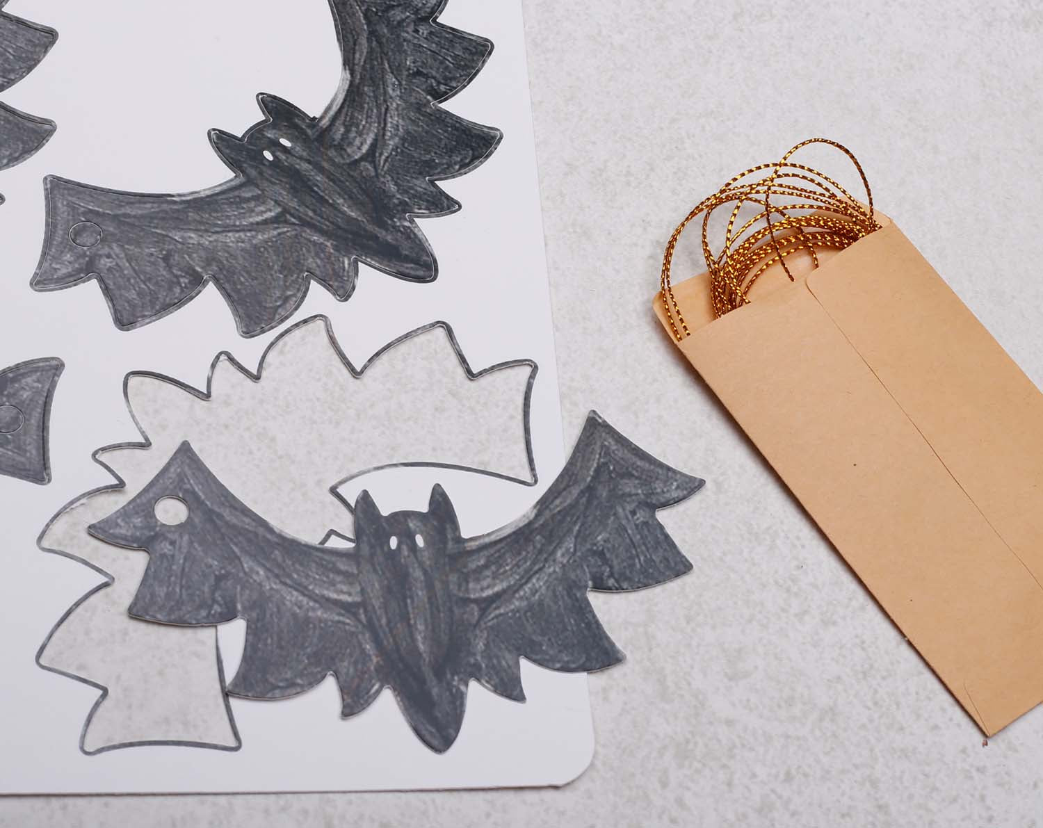 Bat Christmas Gift Tags featuring bat designs and kraft paper envelope for festive packaging.