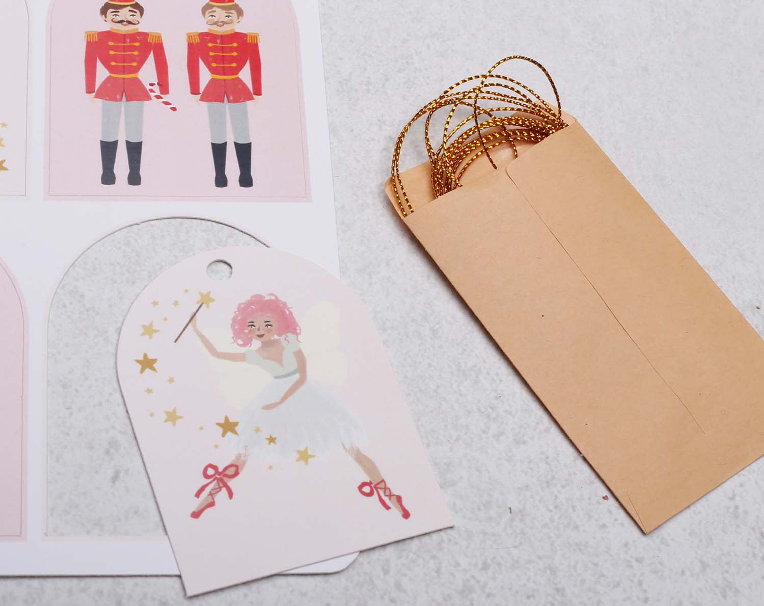 Nutcracker Christmas Gift Tags featuring a pink ballet dancer and a kraft envelope for festive labeling.
