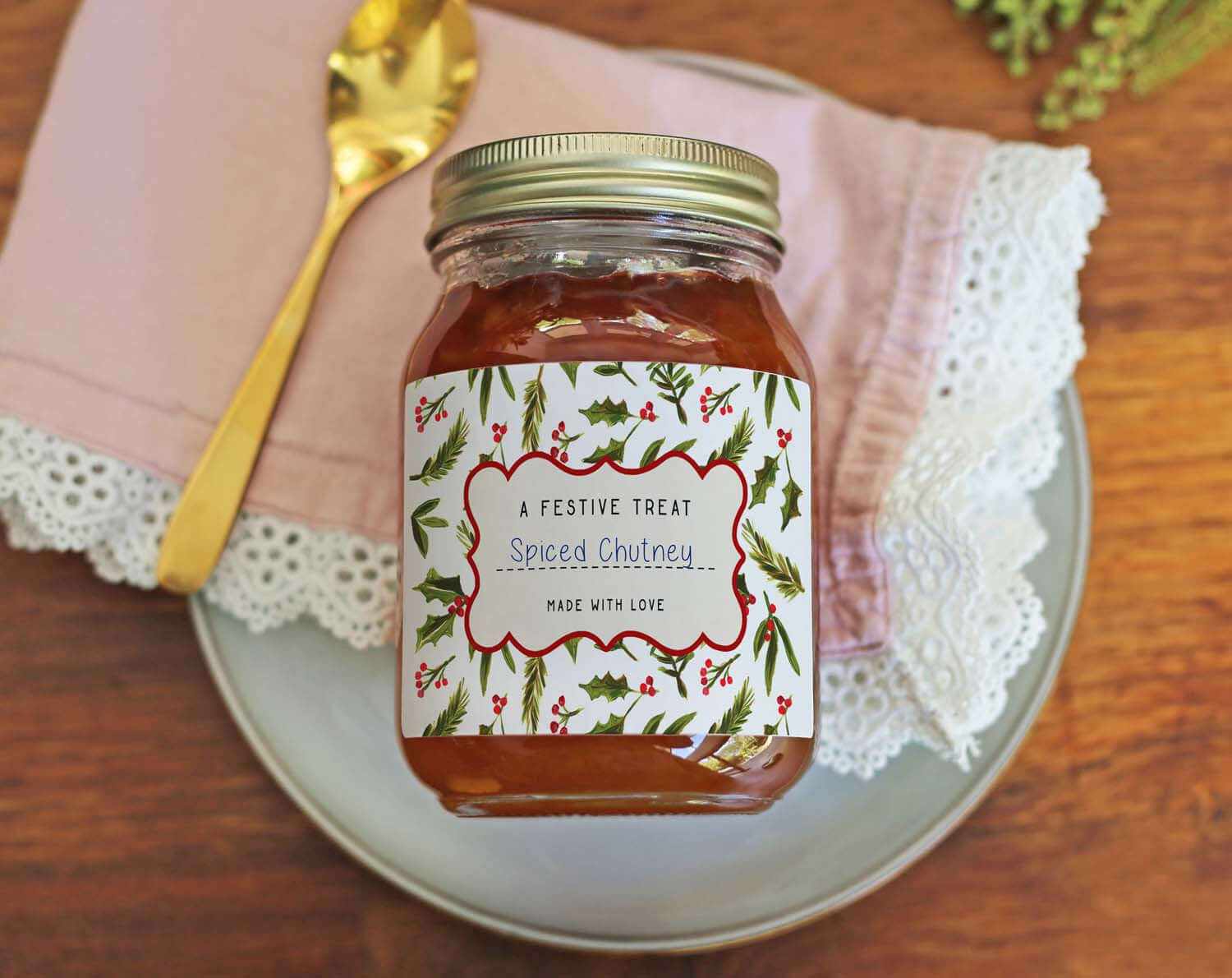 Christmas Jam Jar Labels With Holly on a jar of spiced chutney, decorated with festive holly design.