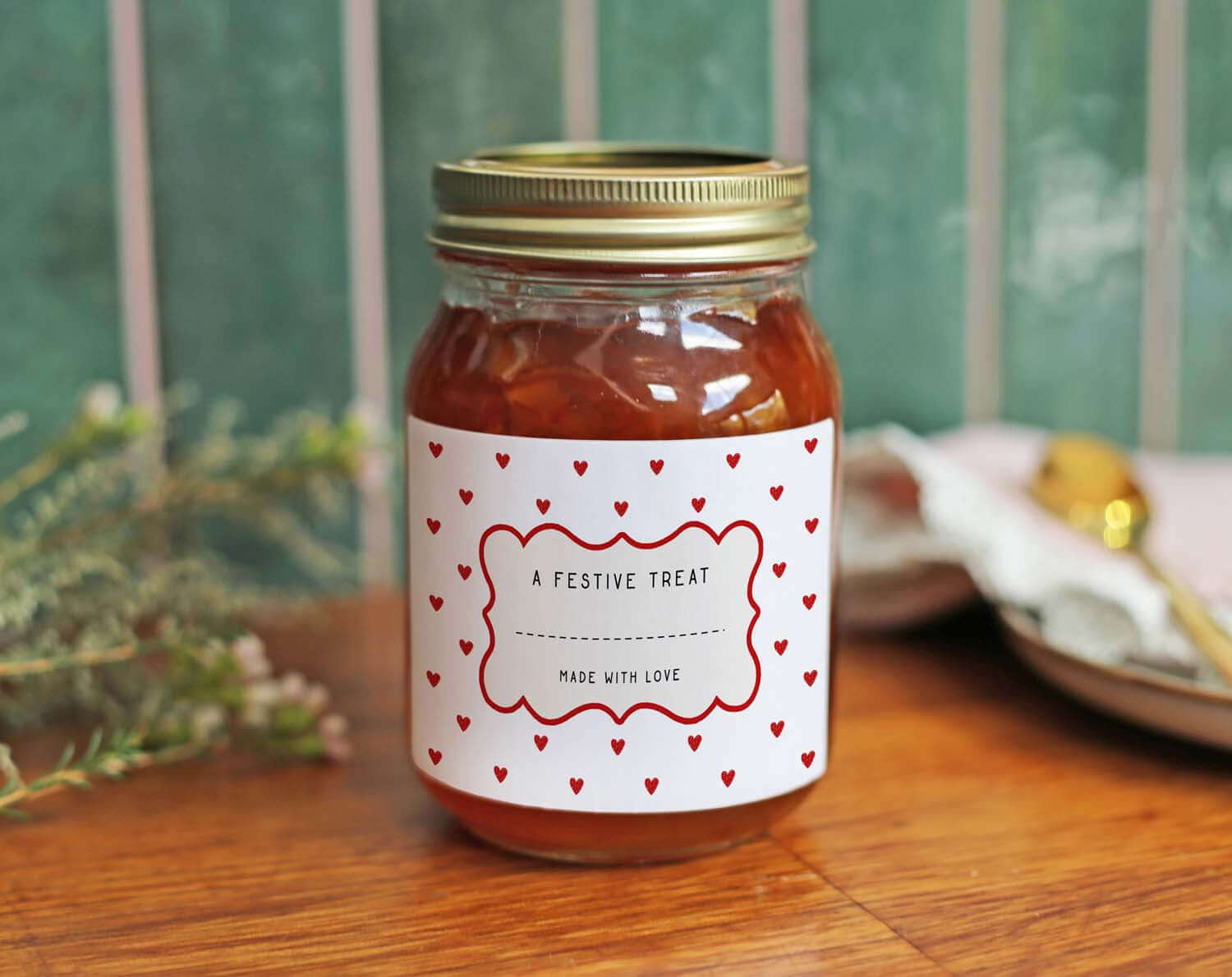 Christmas Jam Jar Labels With Red Hearts on a festive treat jar, decorated with red hearts and a gold lid.