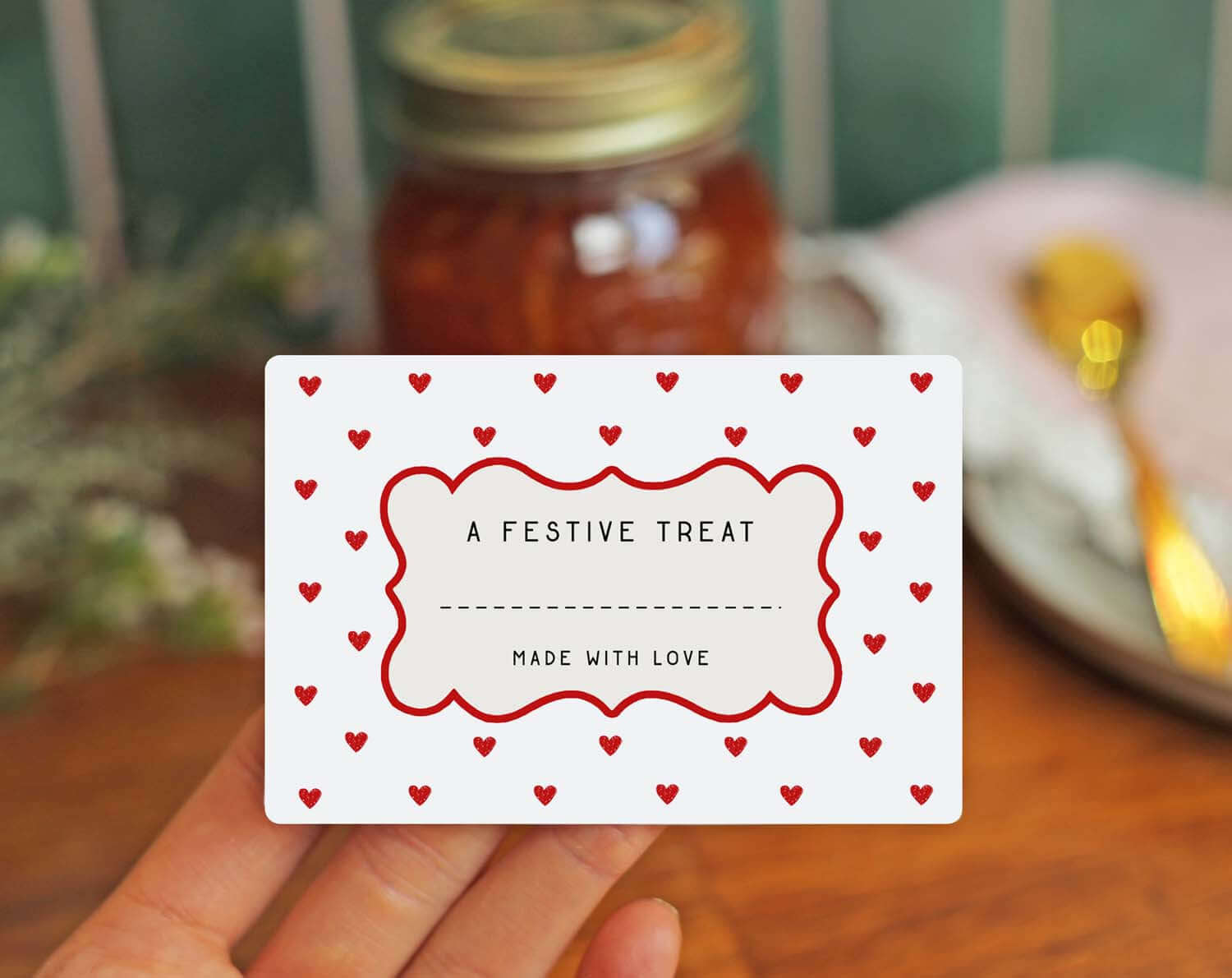 Christmas Jam Jar Labels With Red Hearts featuring a decorative card that says 'A Festive Treat' with red heart accents.