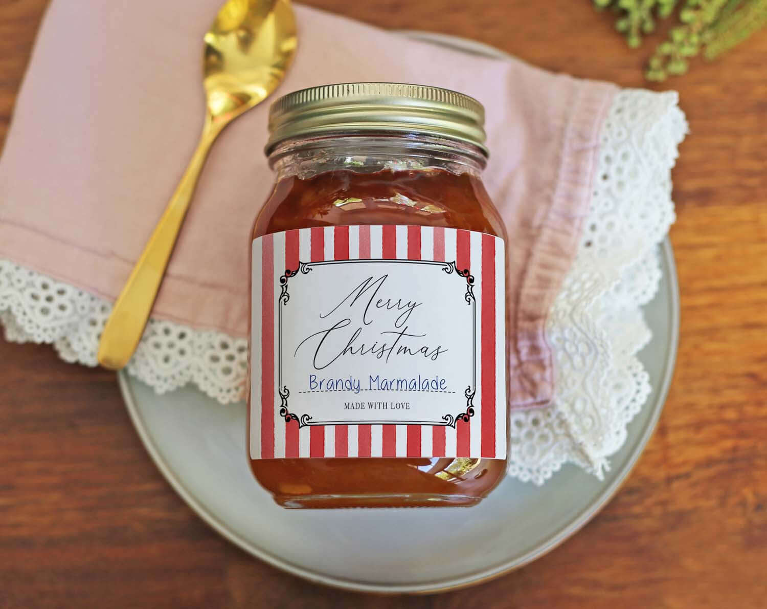 Christmas Jam Jar Labels With Red Stripes on a jar of Brandy Marmalade with a spoon and linen napkin.