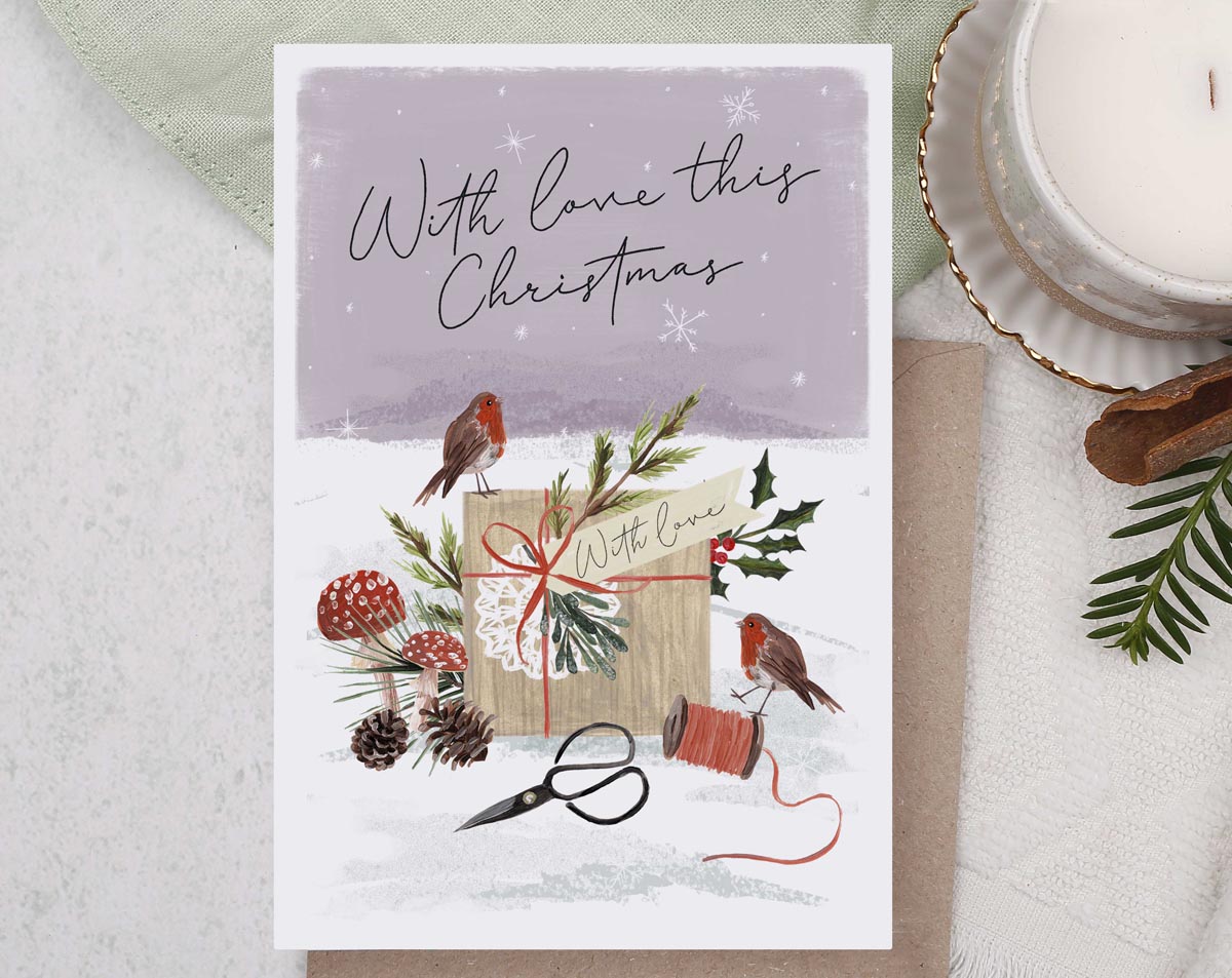 Christmas card, illustrated with a pair of cute robins and a snow filled forest with foliage and mushrooms