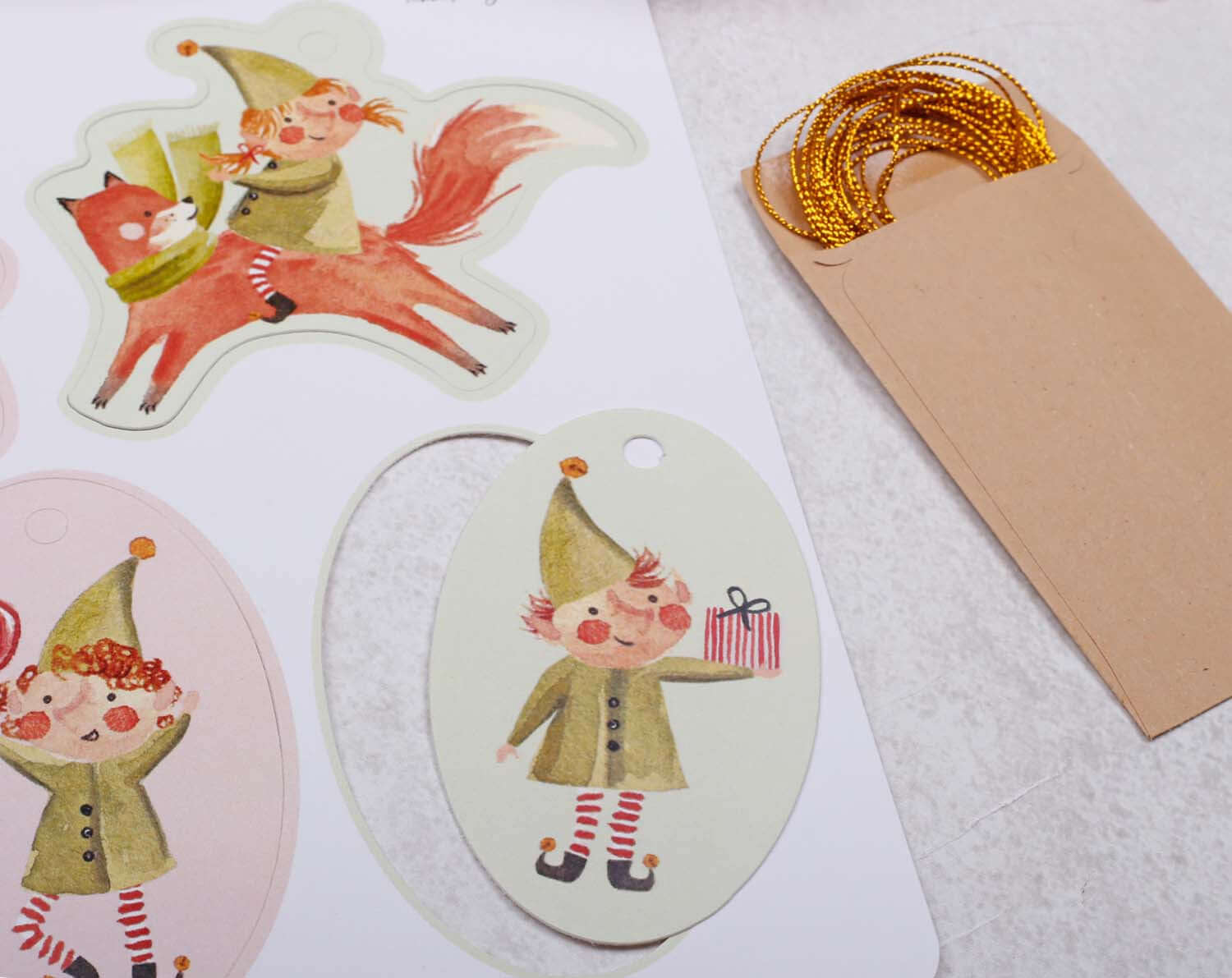 Elf Christmas Gift Tags featuring playful elf illustrations and gold twine for festive gift wrapping.