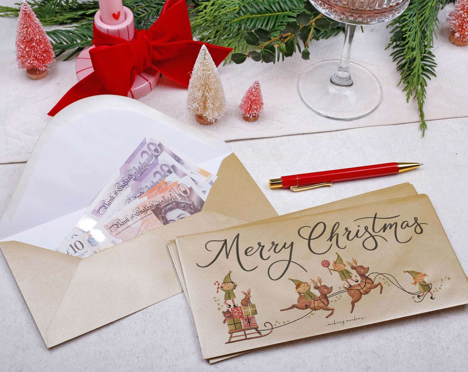 Elf Christmas Money Envelopes with cash inside, featuring a festive 'Merry Christmas' design, perfect for holiday gifting.