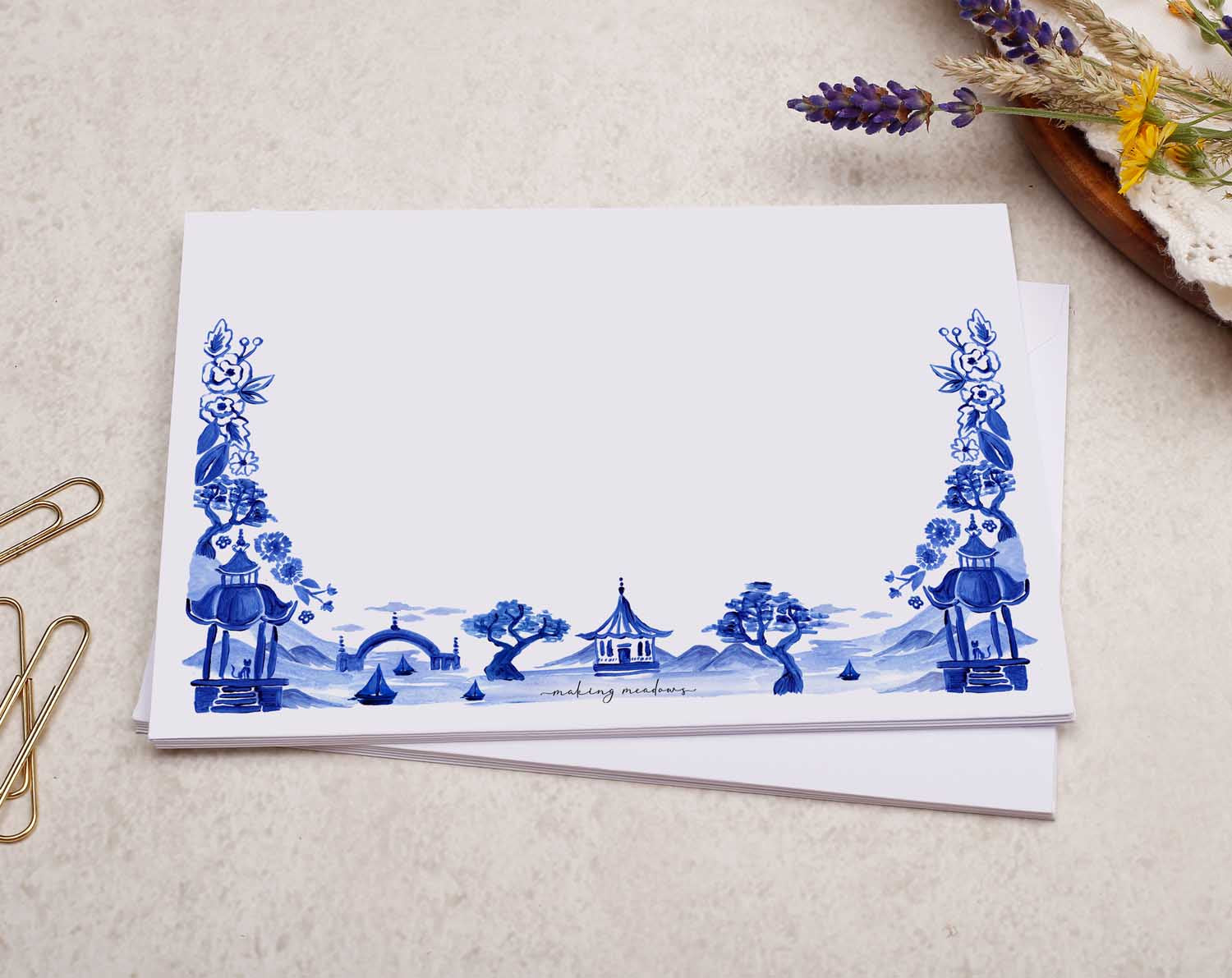 A pretty decorated C6 white envelope with a blue Japanese landscape design. 
