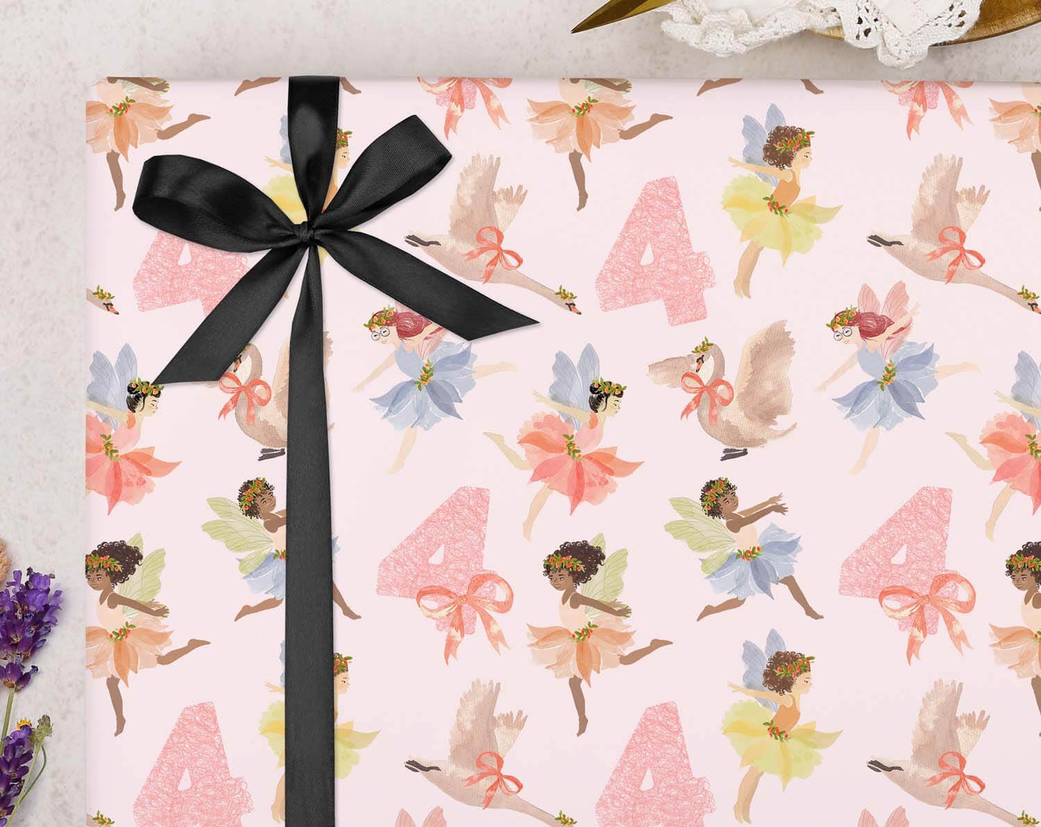 Fairy 4th Birthday Wrapping Paper with a pink fairy design and black ribbon.