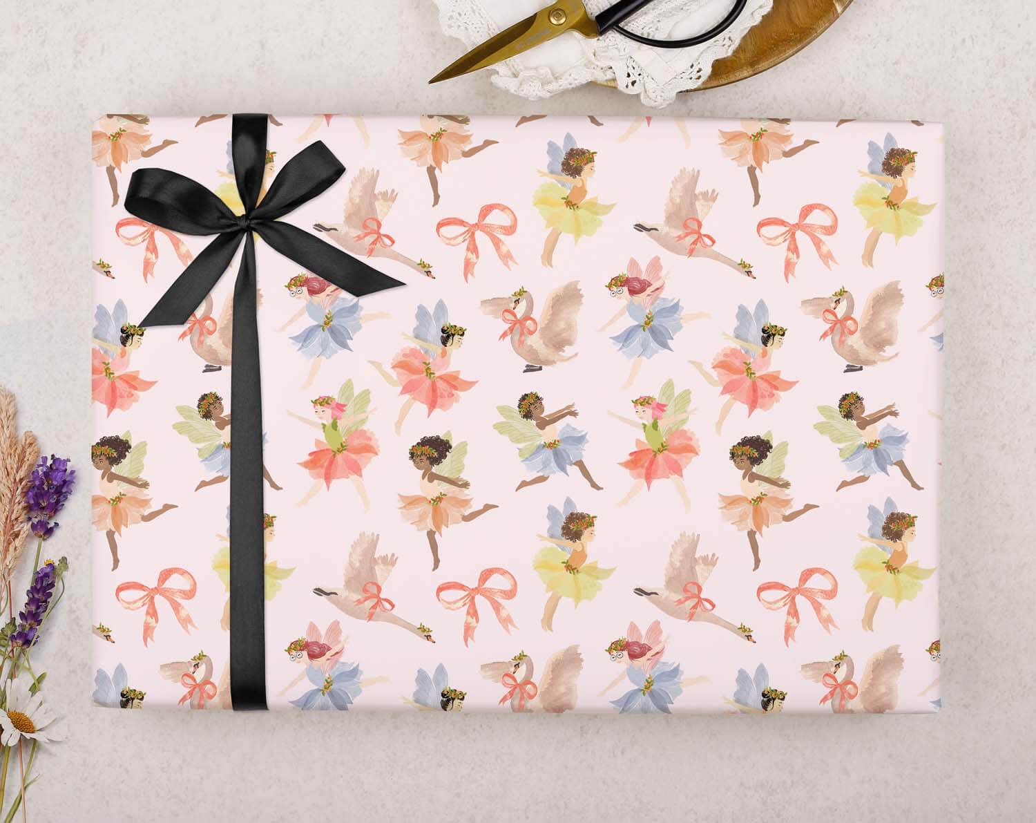Fairy Birthday Wrapping Paper in pink with black ribbon, featuring cute fairy patterns perfect for little girls' birthdays.