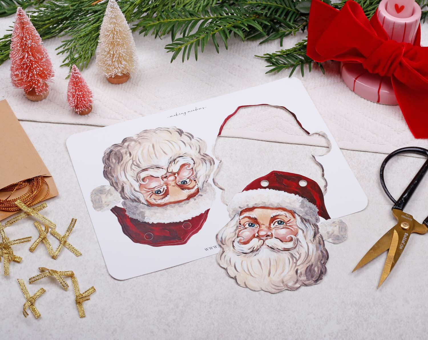 Father Christmas Bunting featuring jolly Santa Claus designs on festive decorations with scissors and craft supplies.