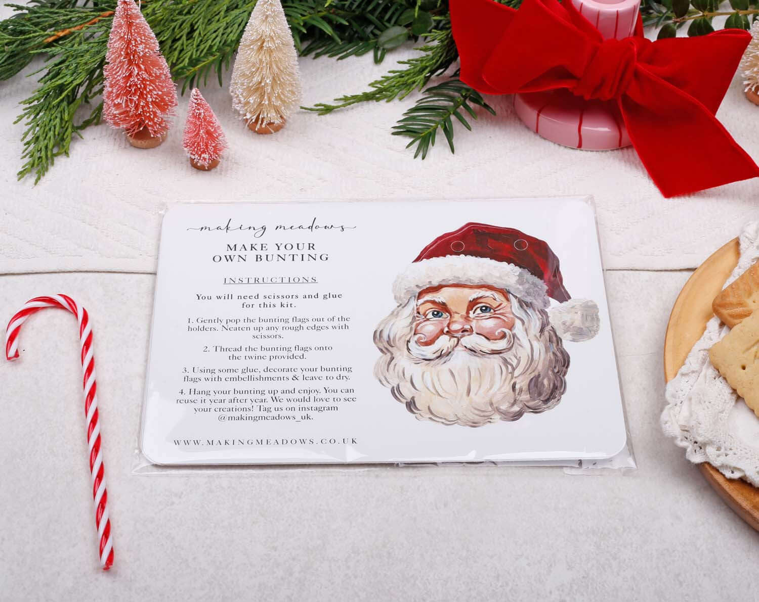Father Christmas Bunting instructions with festive decorations and cookies on a table.