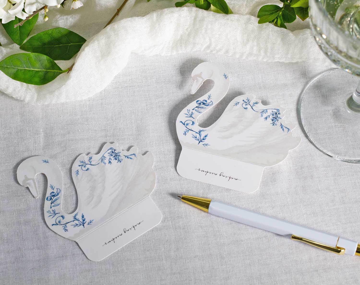 Floral Swan Wedding Place Cards elegantly designed in swan shape, featuring delicate blue floral patterns for table settings.