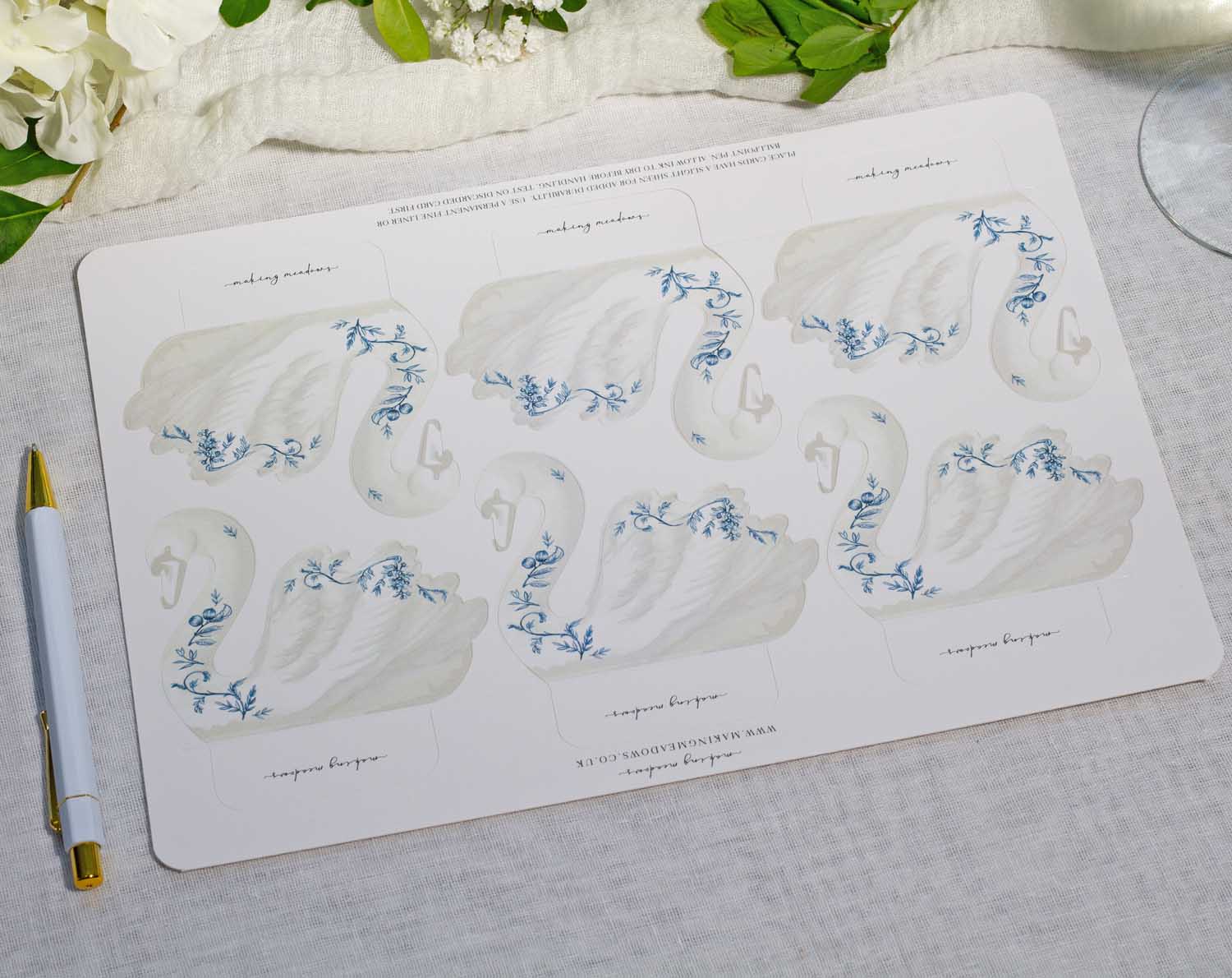 Floral Swan Wedding Place Cards featuring elegant swan designs with delicate blue florals for wedding table settings.