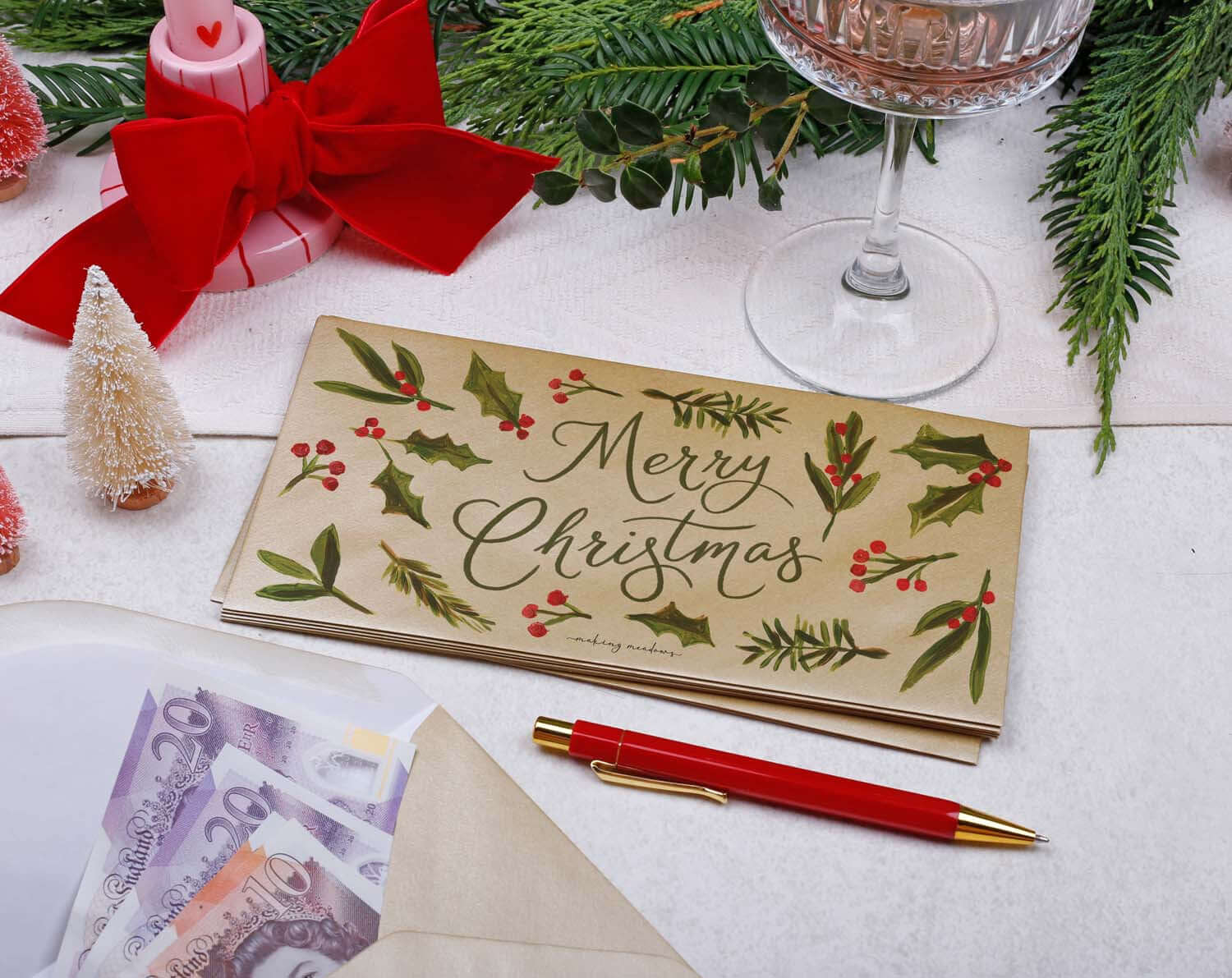 Foliage Christmas Money Envelopes with Merry Christmas design and festive decorations.