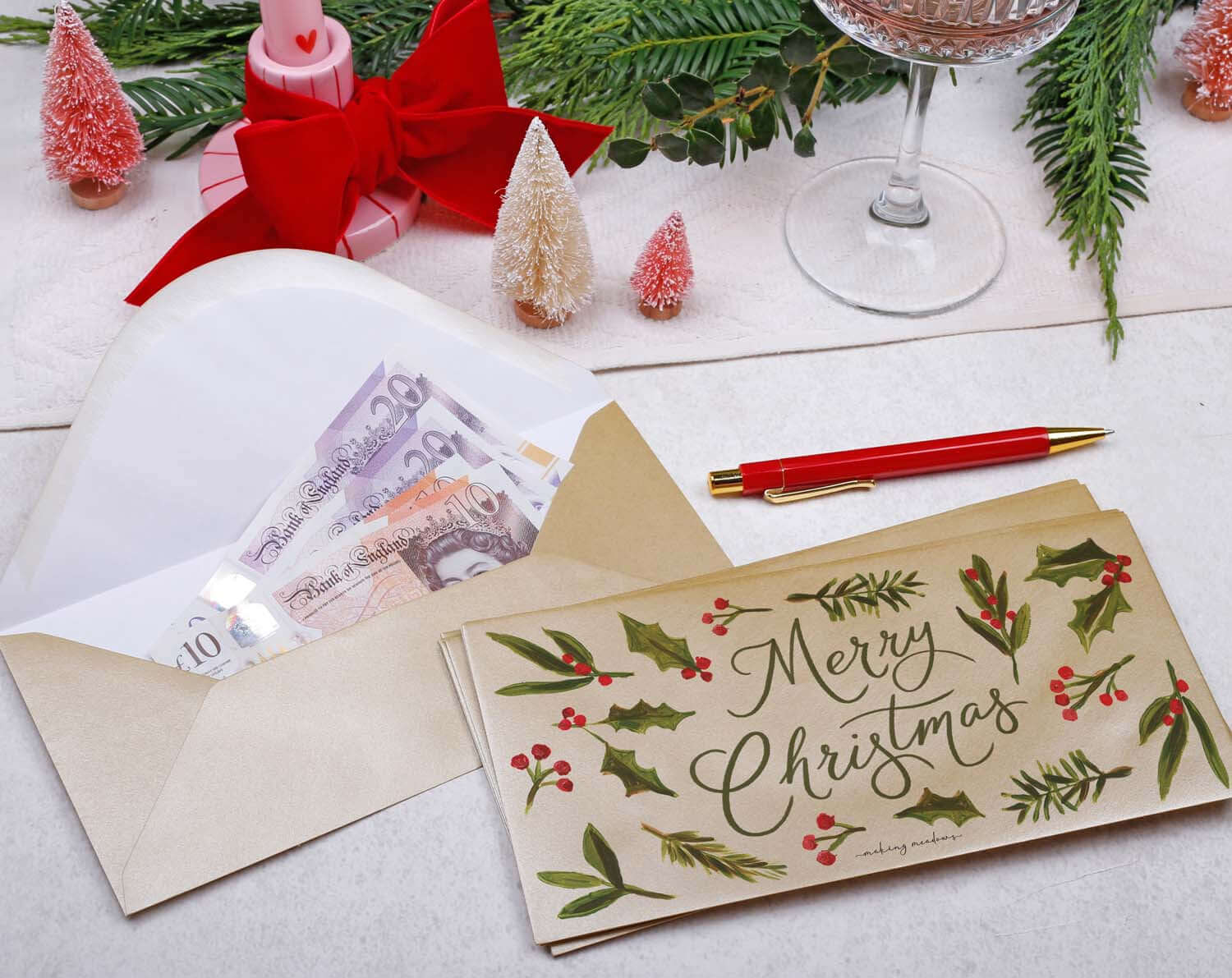 Foliage Christmas Money Envelopes featuring a festive design with cash and botanical decorations.