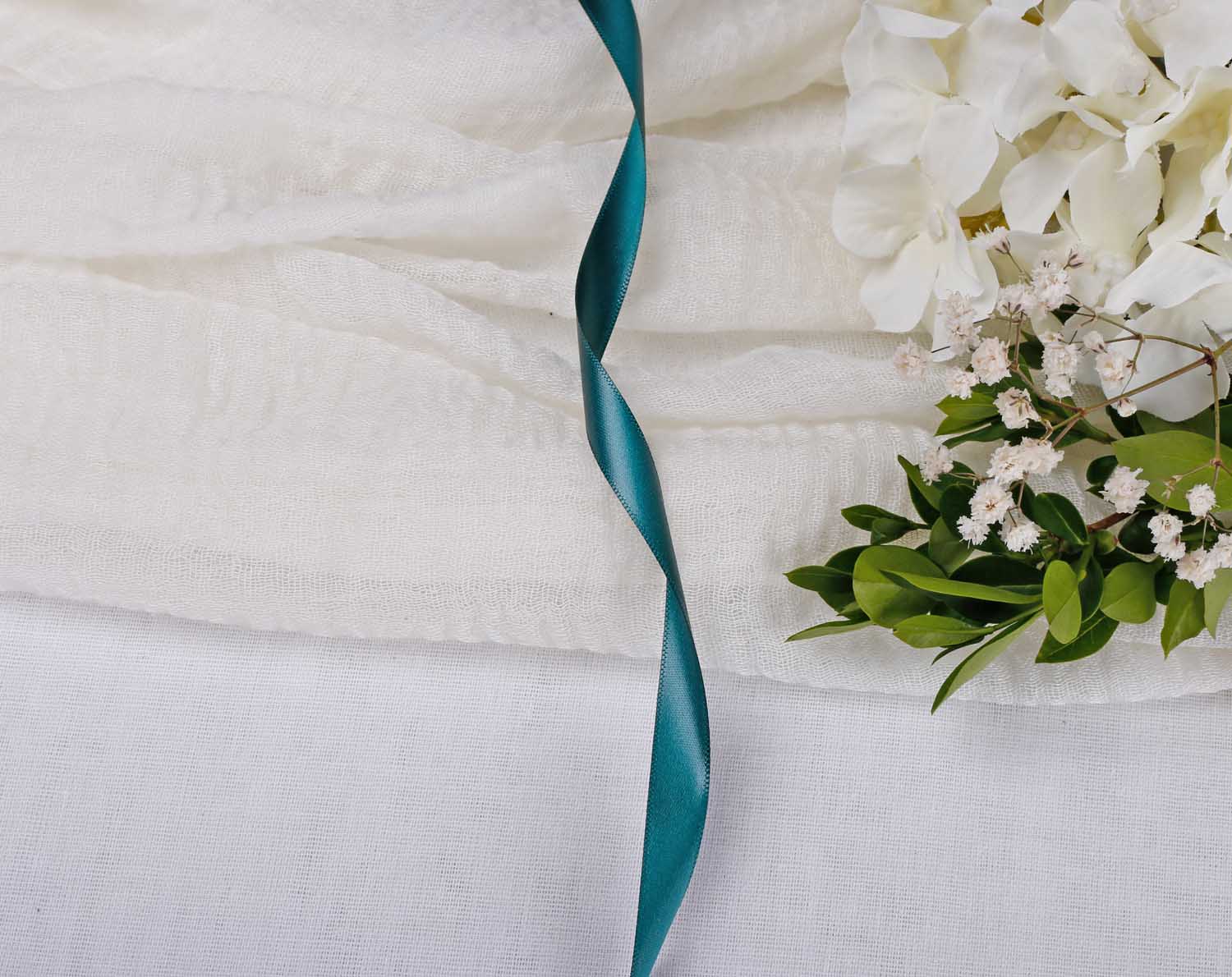 Forest Green Satin Ribbon For Wedding elegantly displayed with flowers and fabric.