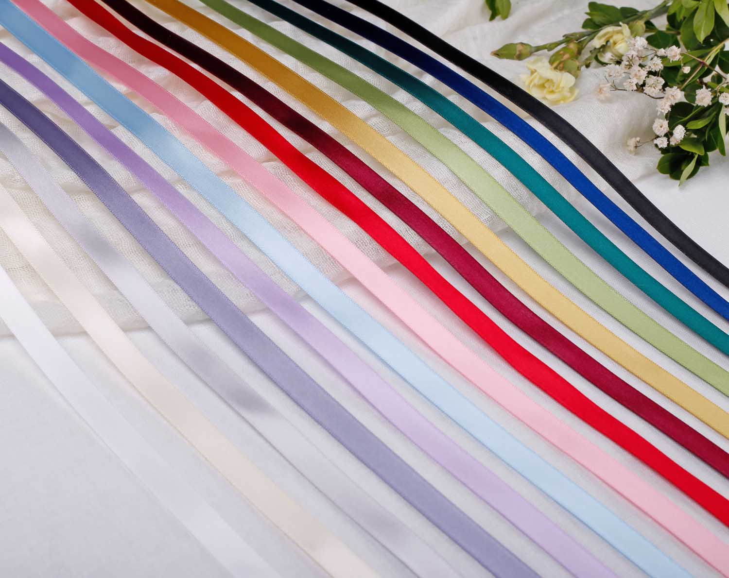 A variety of colourful satin ribbons, including the 10mm Satin Ribbon For Wedding, ideal for elegant wedding decorations.