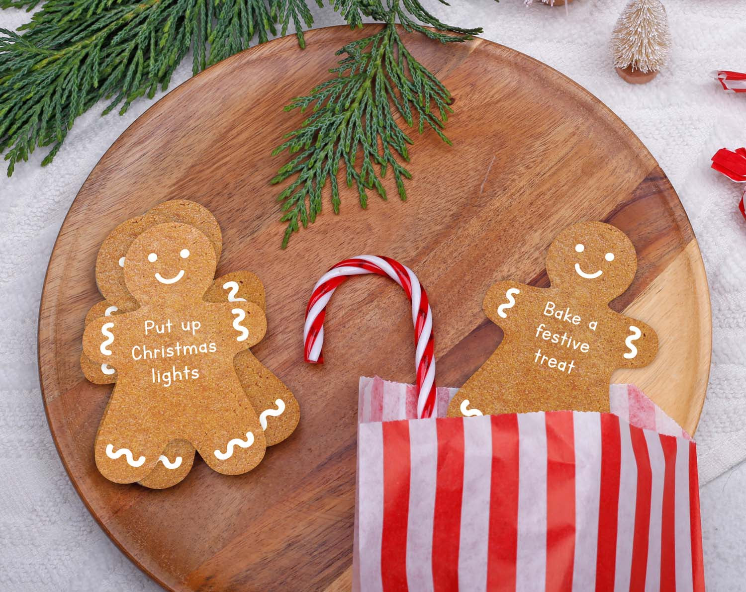 Gingerbread Activity Cards on a wooden plate with festive activities for Advent Calendar.