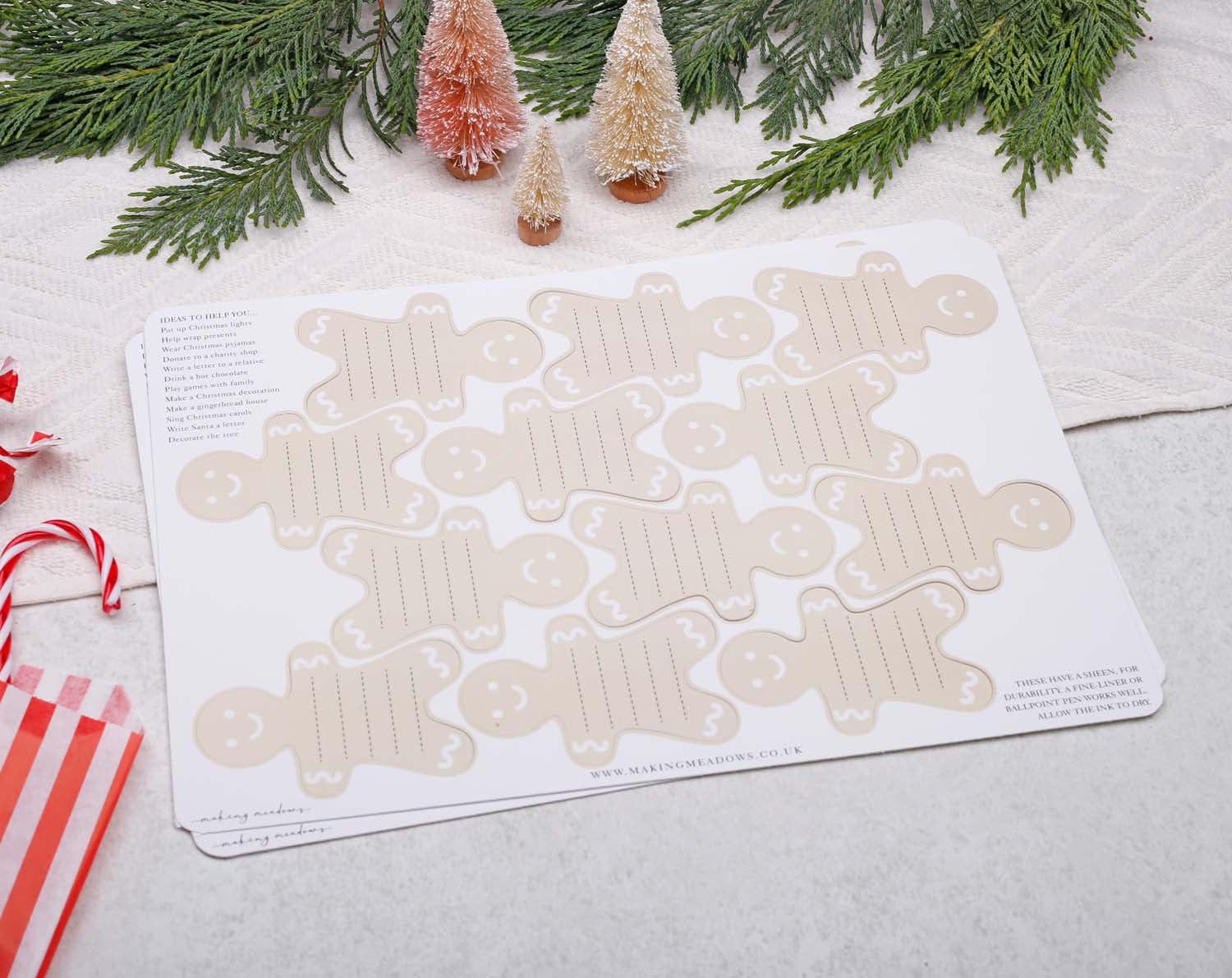 Gingerbread Fill Your Own Activity Cards displayed on a table with festive decorations and candy canes.